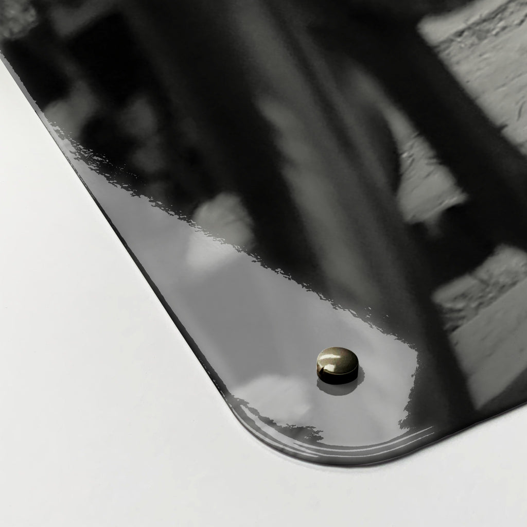 Close-up of the corner of the Cyclists magnetic notice board, showing the gloss finish and a screw cap