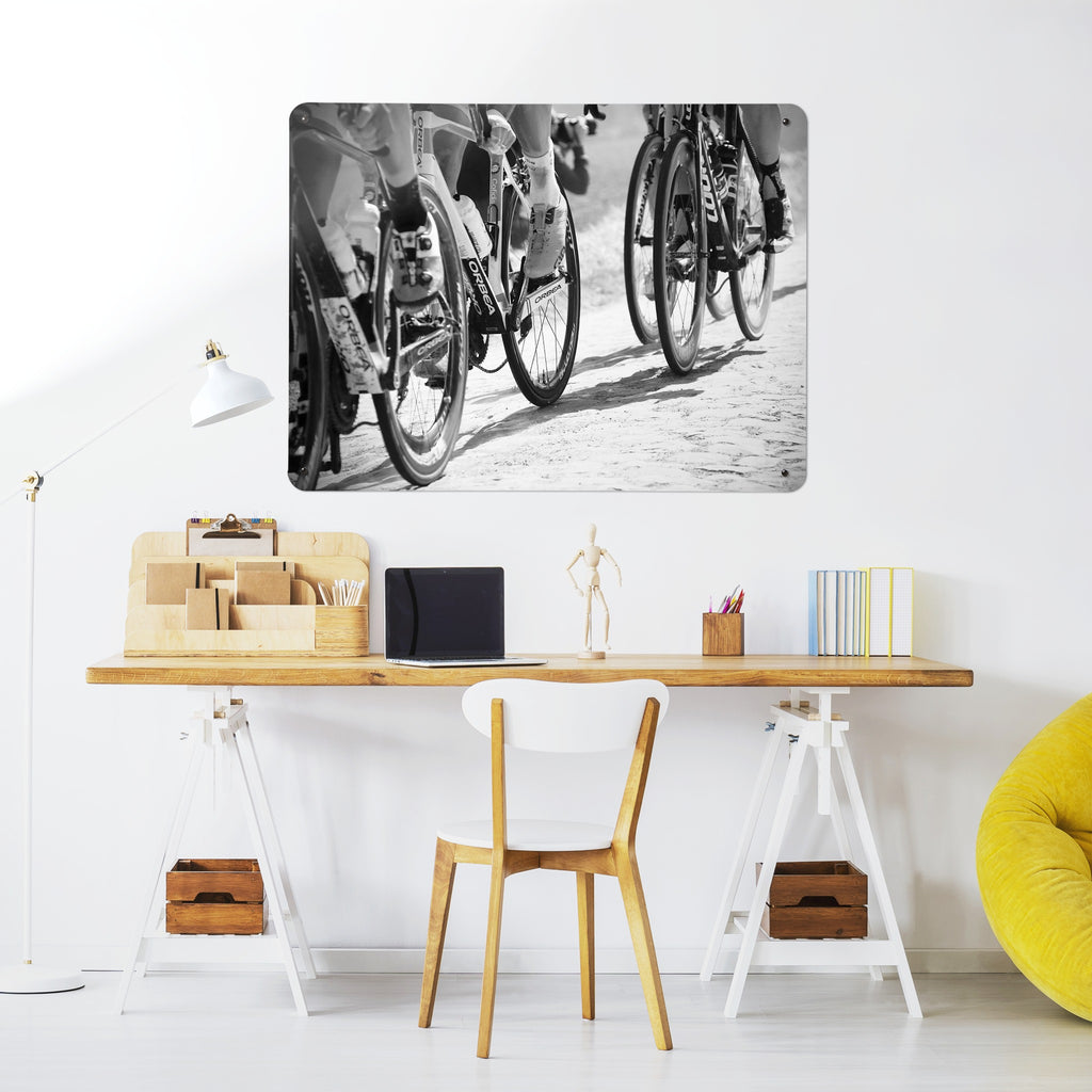 Cyclists magnetic notice board above a desk in a home office