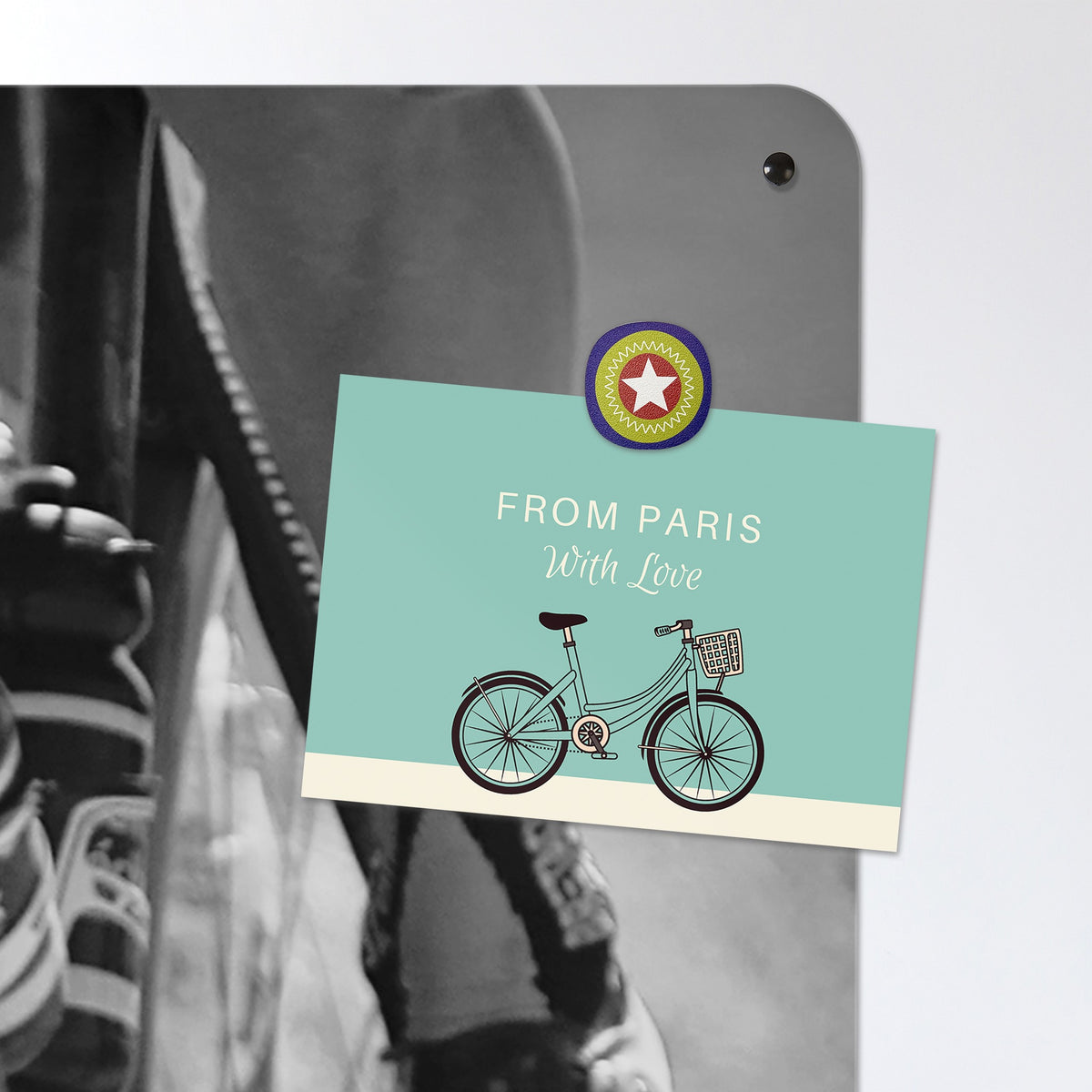 A postcard held by a fridge magnet on the Cyclists magnetic notice board