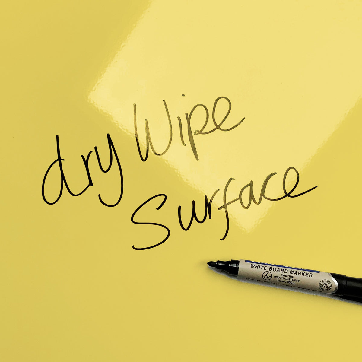 The words dry wipe surface written in marker pen on the Blue/Yellow Daisy The Cow magnetic notice board