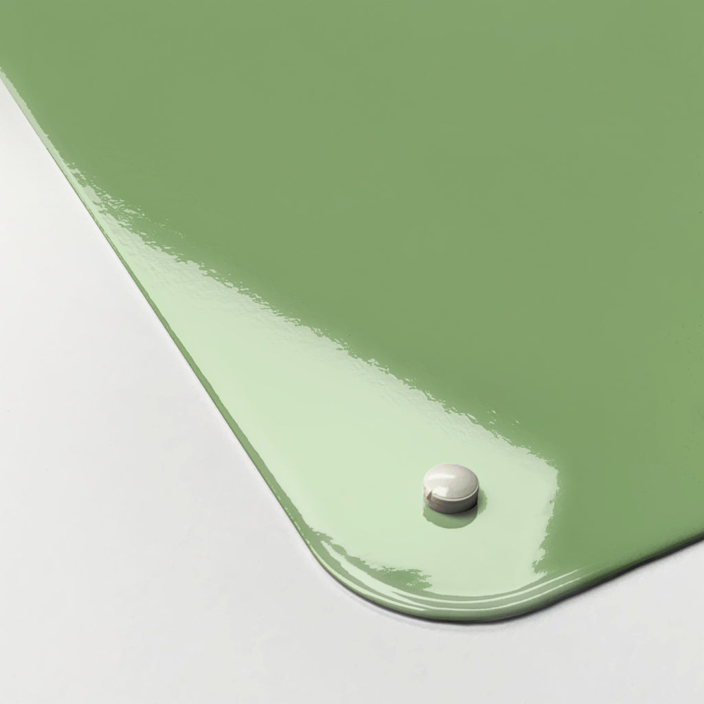 Close-up of the corner of the Dinosaur magnetic notice board in green, showing the gloss finish and a screw cap