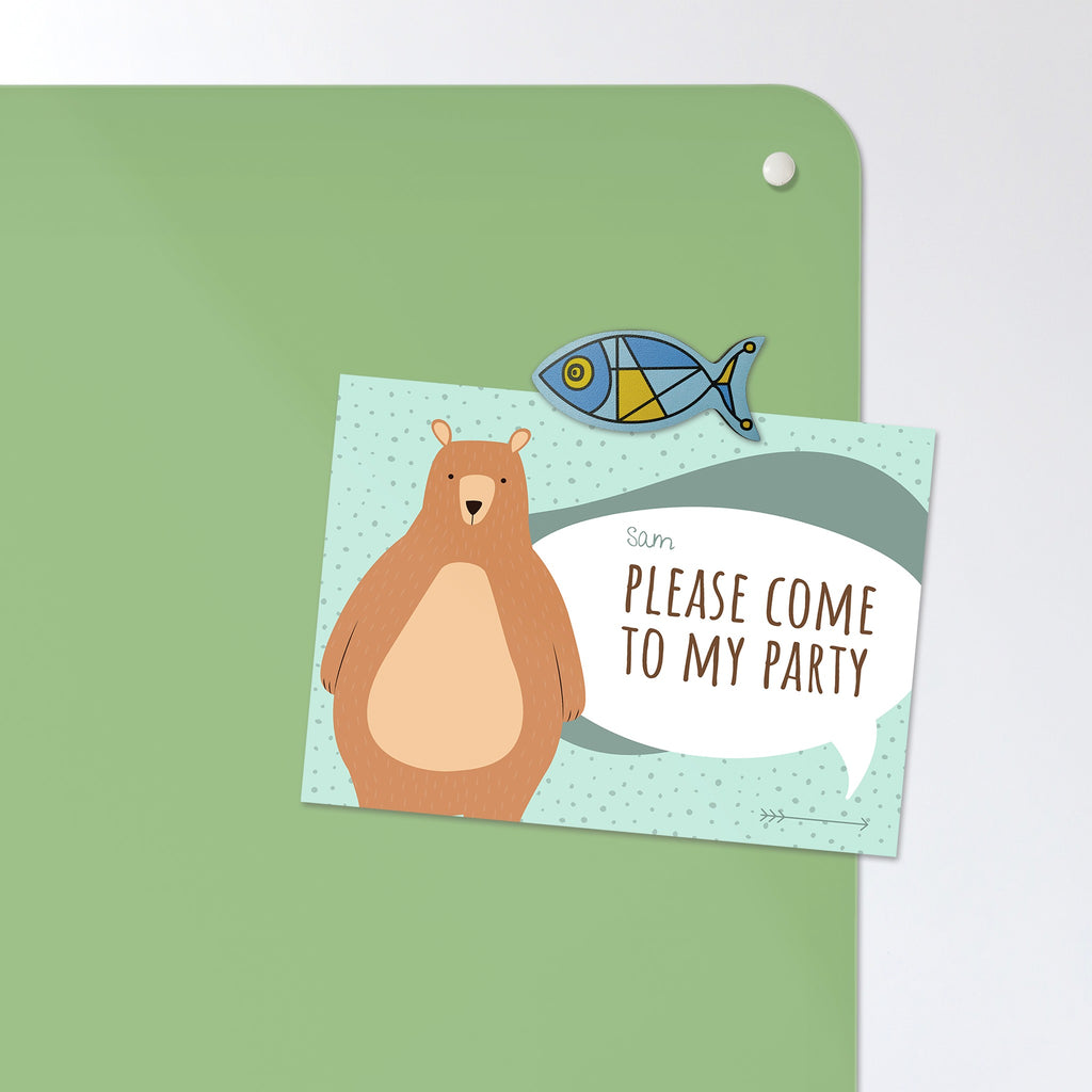 A postcard held by a fridge magnet on the Dinosaur magnetic notice board in green