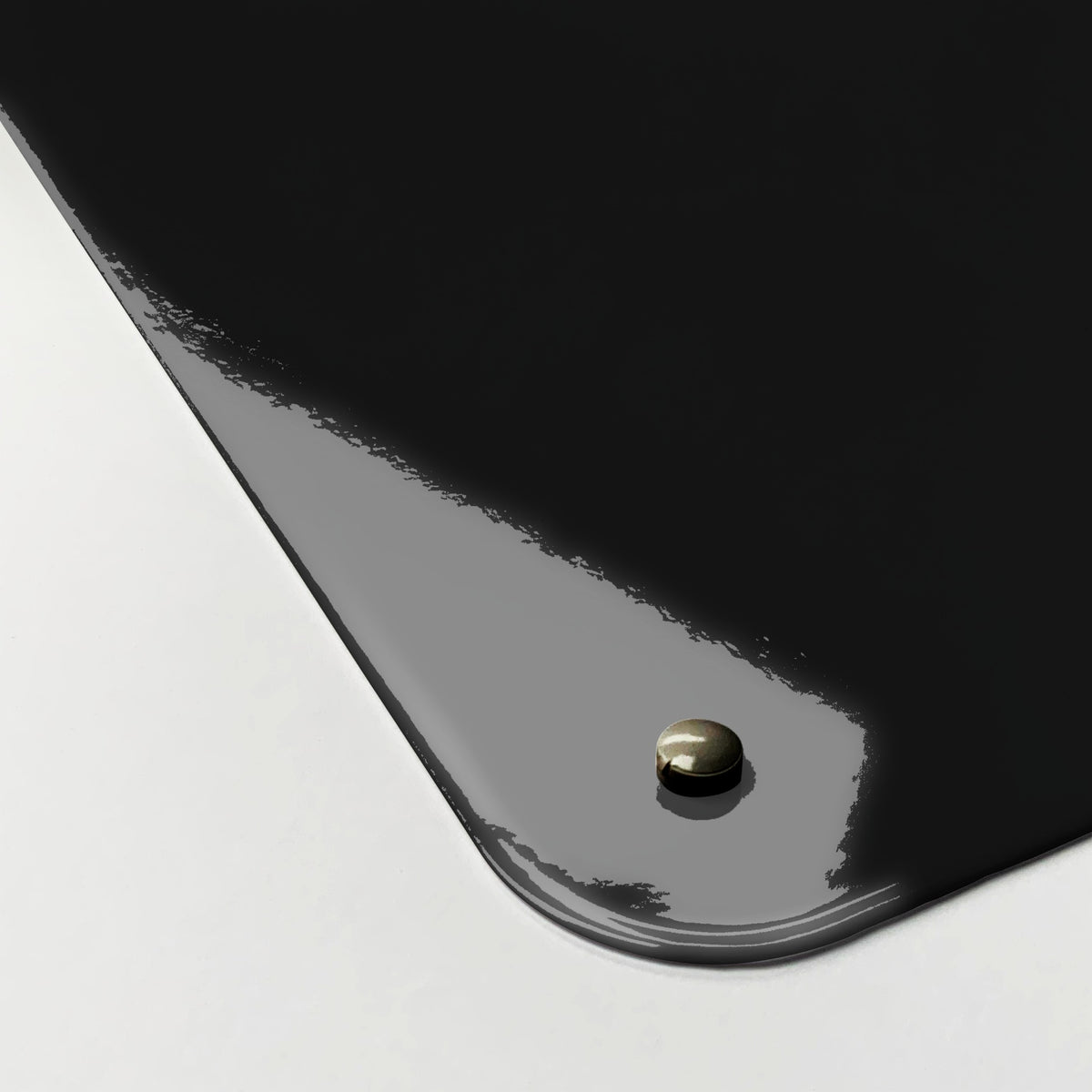 Close-up of the corner of the Earth From Space magnetic notice board, showing the gloss finish and a screw cap