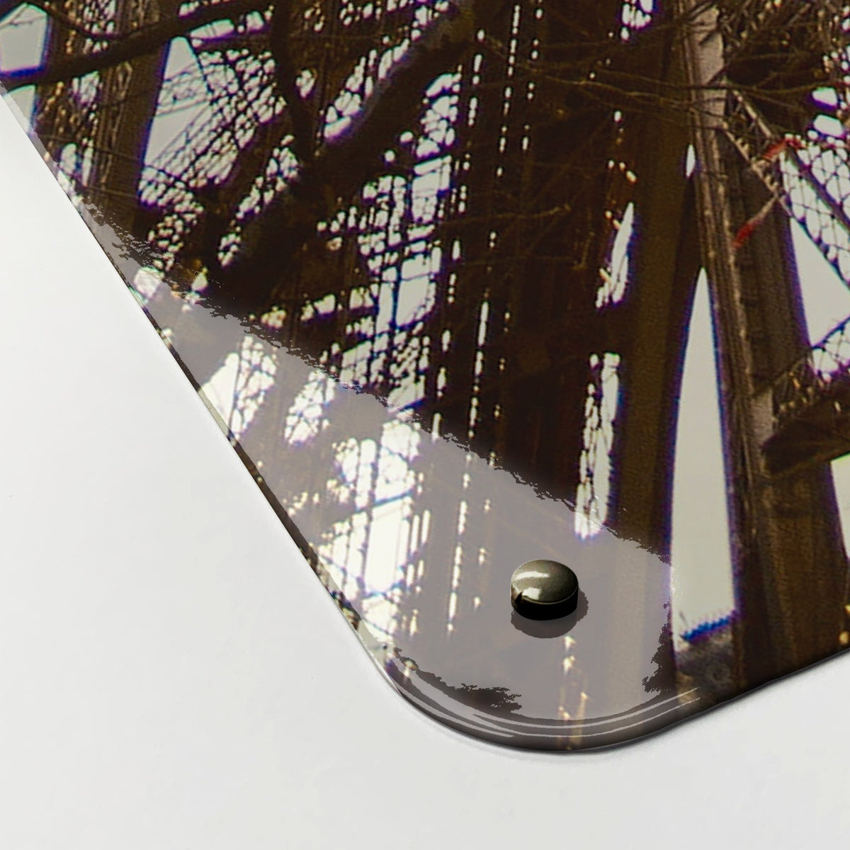Close-up of the corner of the Eiffel Tower magnetic notice board, showing the gloss finish and a screw cap