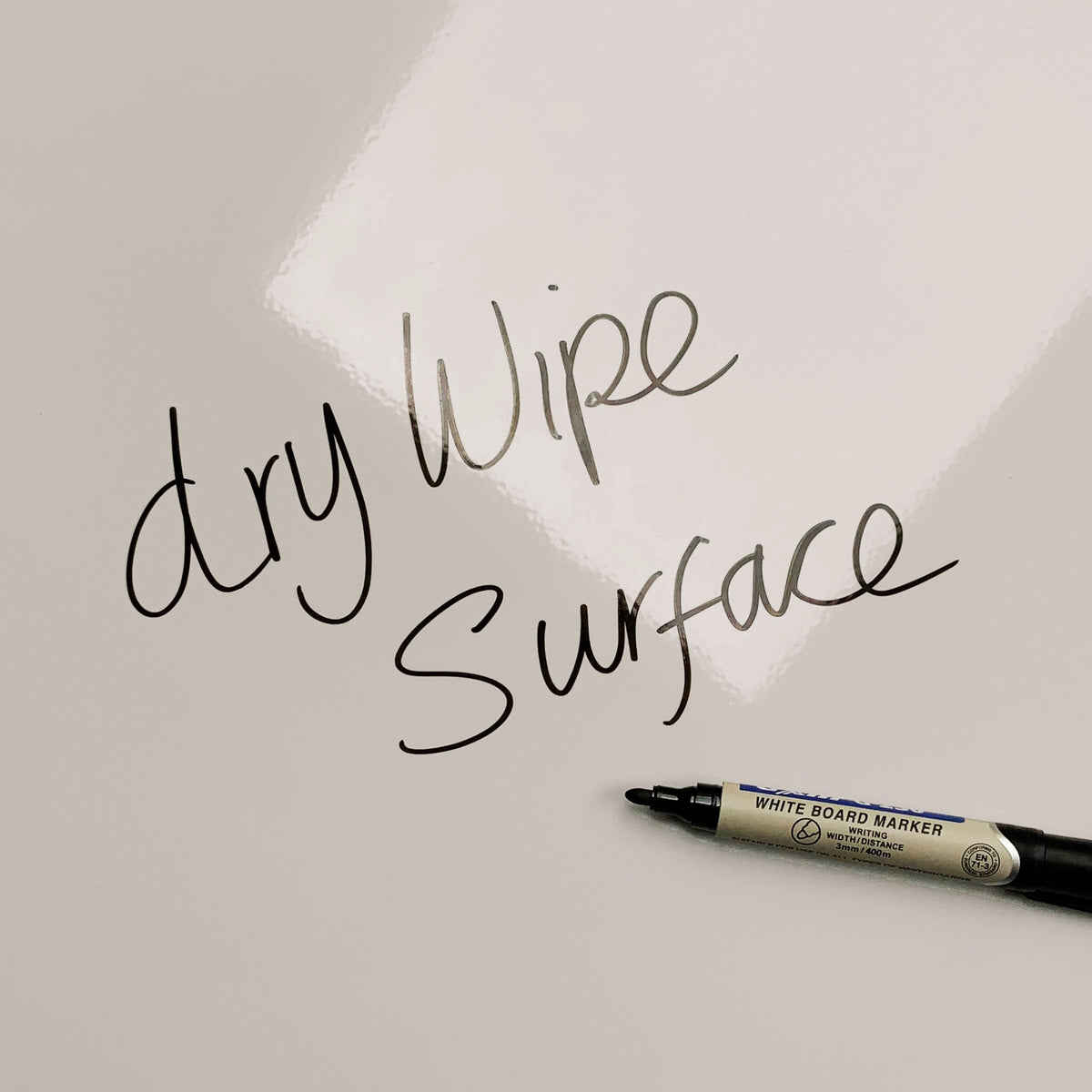The words dry wipe surface written in marker pen on the Eiffel Tower magnetic notice board