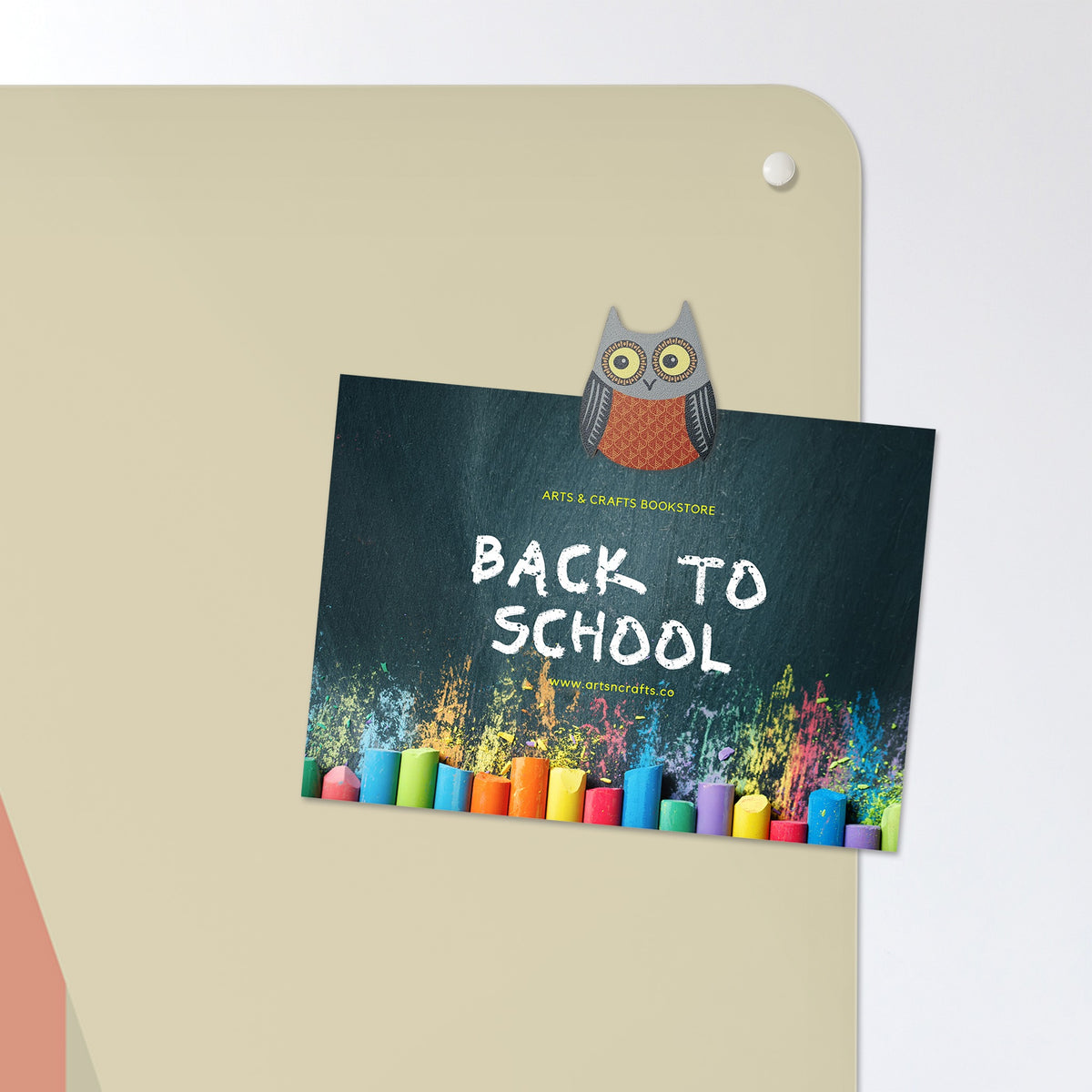 A postcard held by a fridge magnet on the Fair Isle Owl magnetic notice board in Olive/Coral