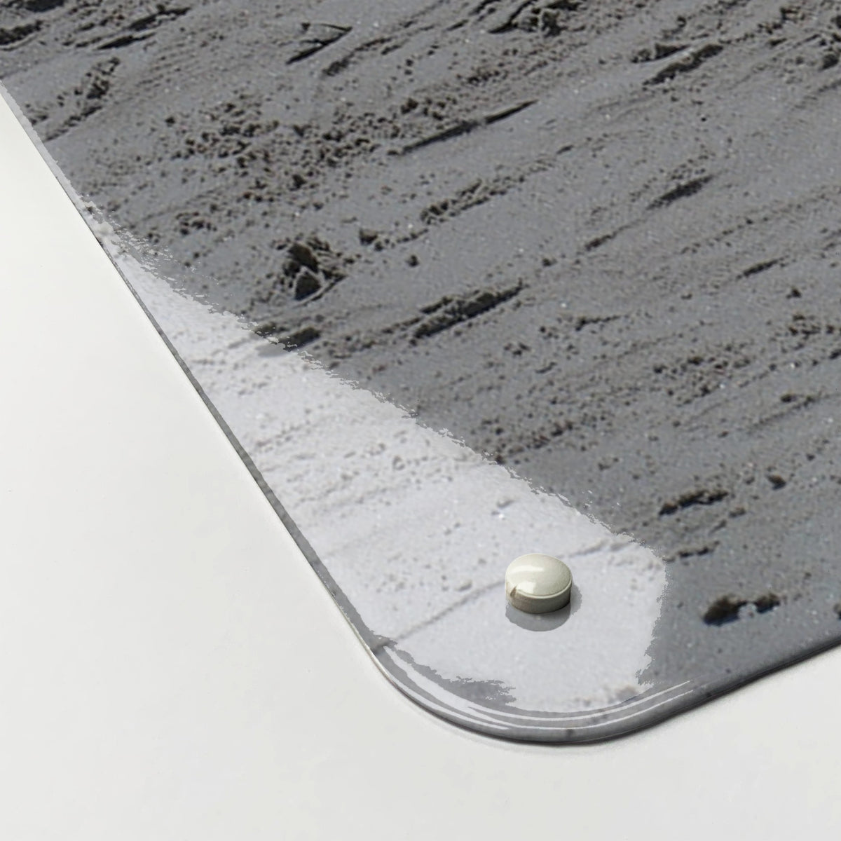 Close-up of the corner of the Fishing Tackle magnetic notice board, showing the gloss finish and a screw cap