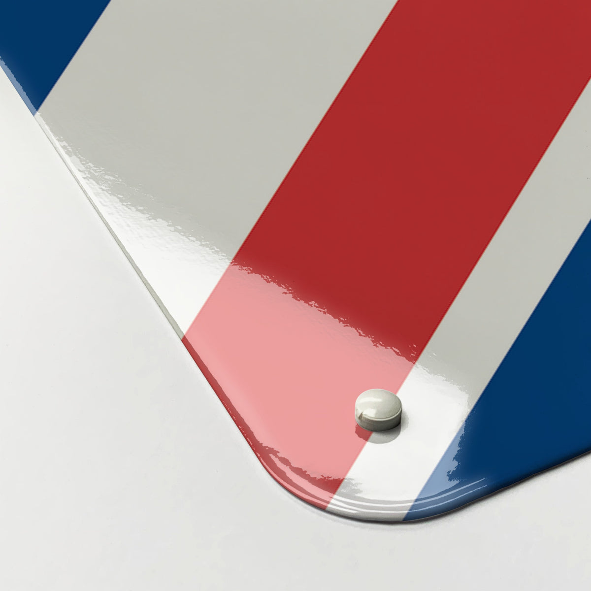 Close-up of the corner of the Flags magnetic notice board in Union Jack, showing the gloss finish and a screw cap