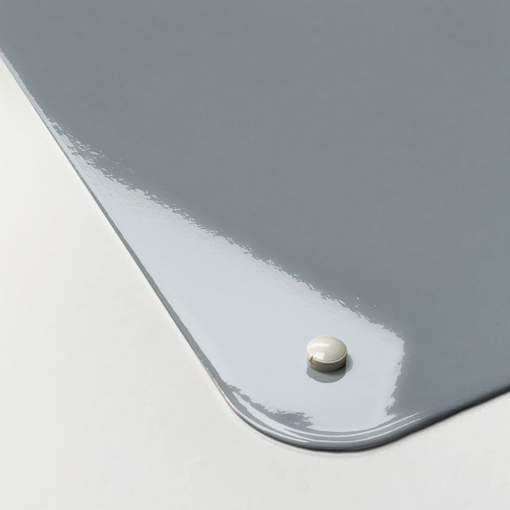 Close-up of the corner of the Flatiron Building magnetic notice board, showing the gloss finish and a screw cap