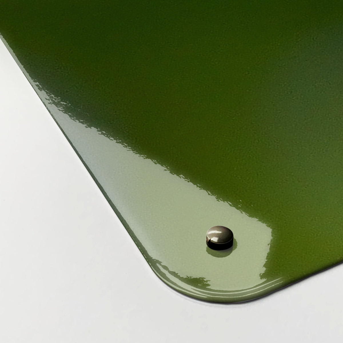 Close-up of the corner of the Forget Me Not magnetic notice board, showing the gloss finish and a screw cap