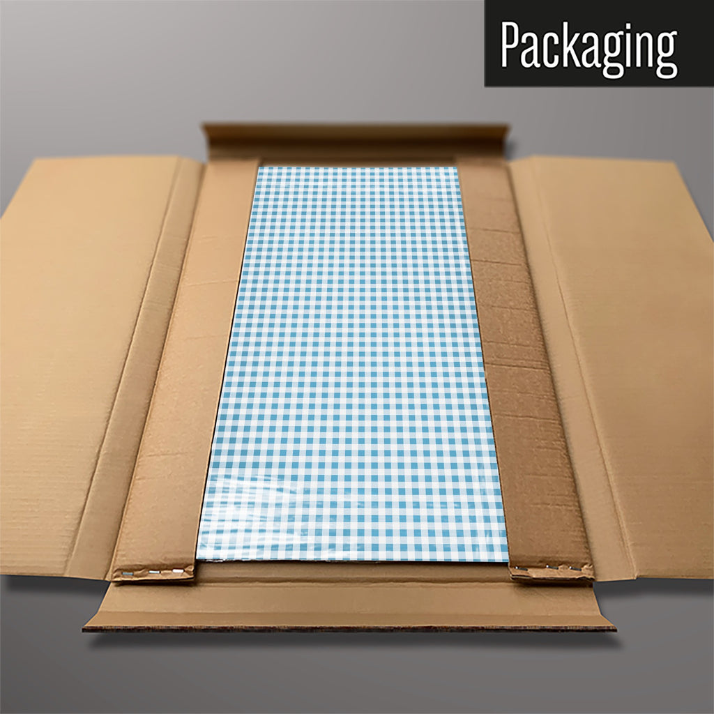 The Gingham magnetic notice board in Blue packed flat in its cardboard box