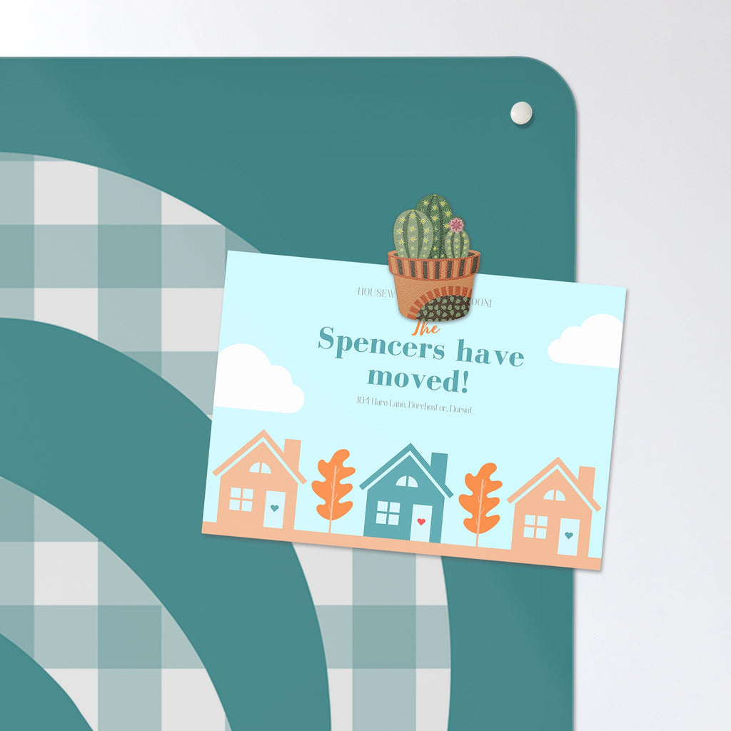 A postcard held by a fridge magnet on the Gingham Cockerel magnetic notice board in blue