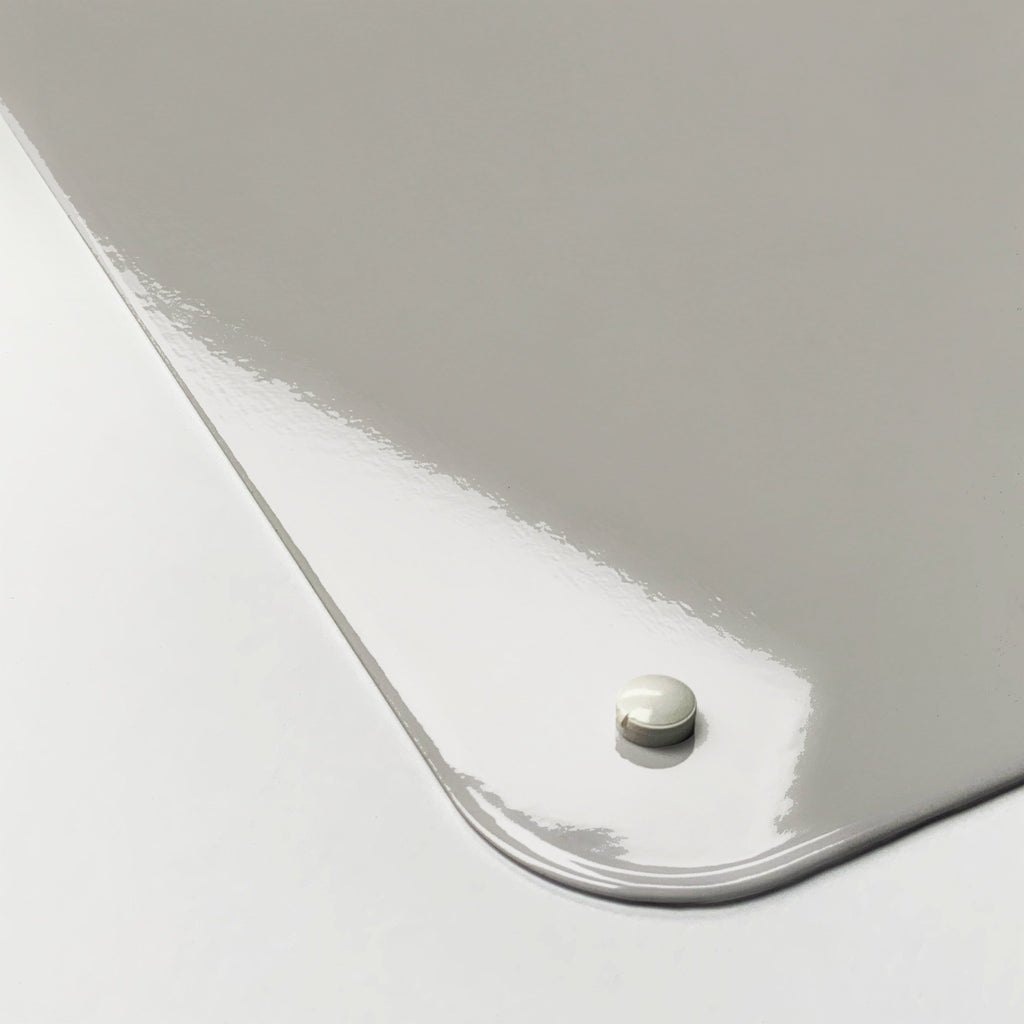 Close-up of the corner of the Golden Retriever Puppy magnetic notice board, showing the gloss finish and a screw cap