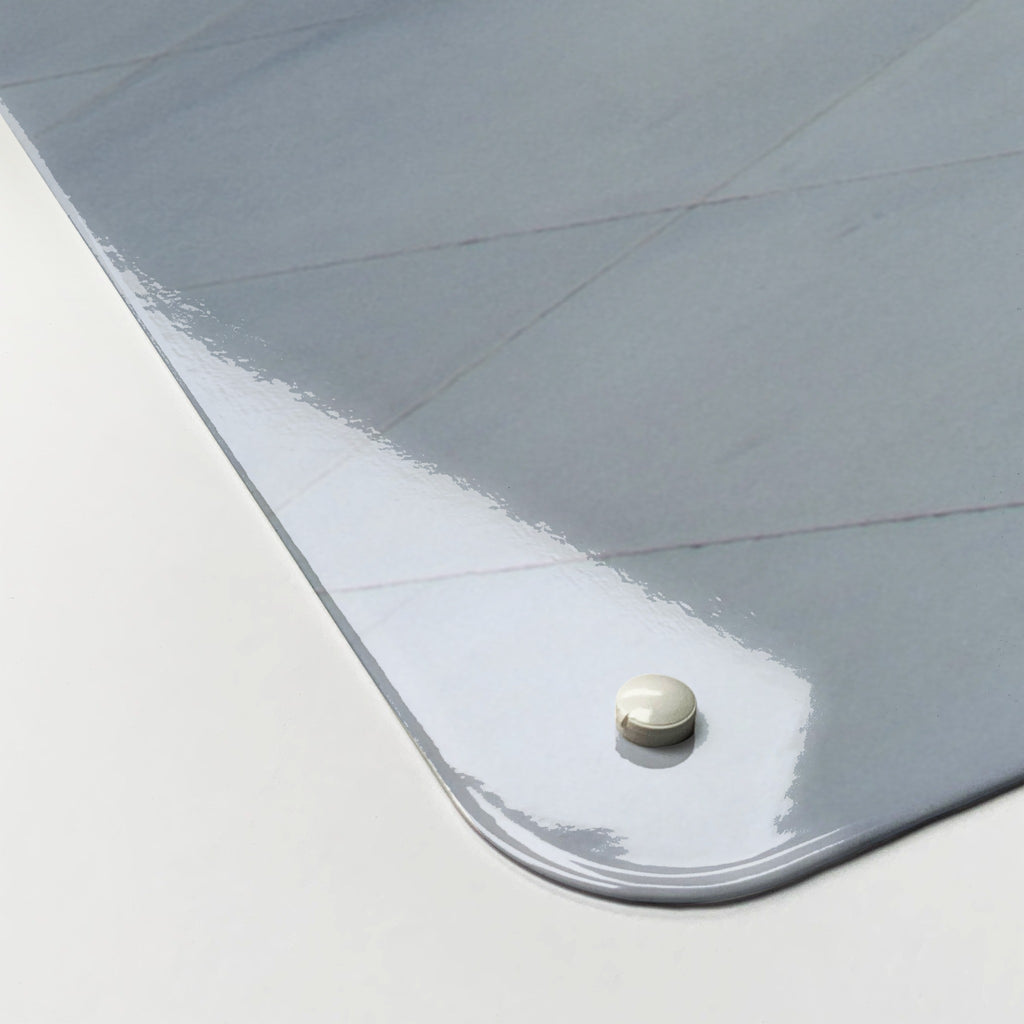 Close-up of the corner of the Heydar Aliyev Centre magnetic notice board, showing the gloss finish and a screw cap