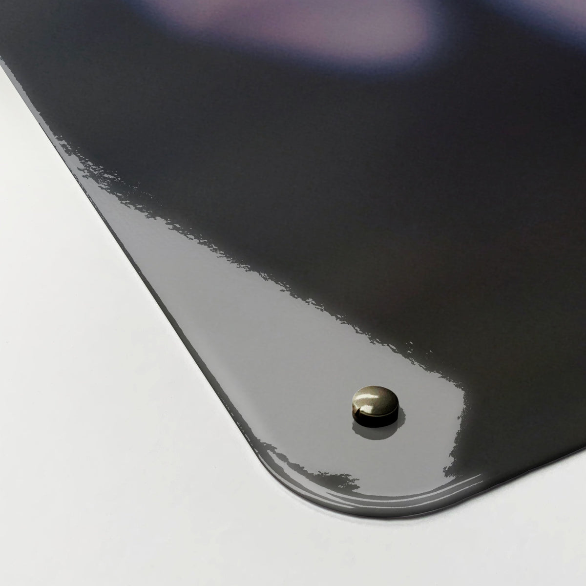 Close-up of the corner of the Lilac magnetic notice board, showing the gloss finish and a screw cap