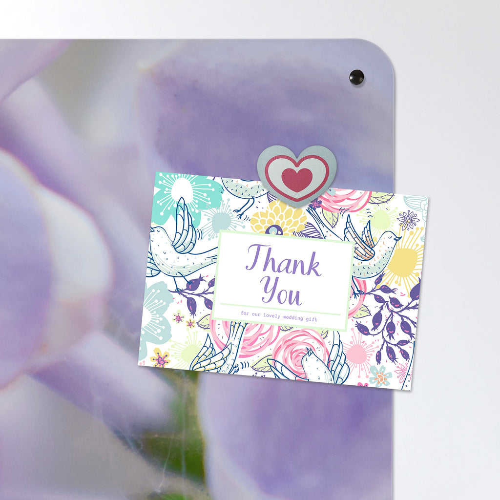 A postcard held by a fridge magnet on the Lilac magnetic notice board