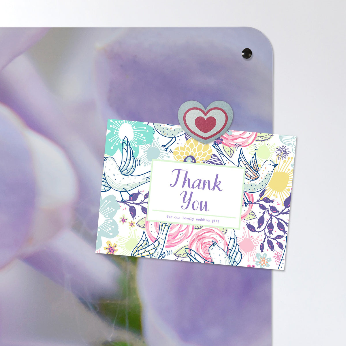 A postcard held by a fridge magnet on the Lilac magnetic notice board