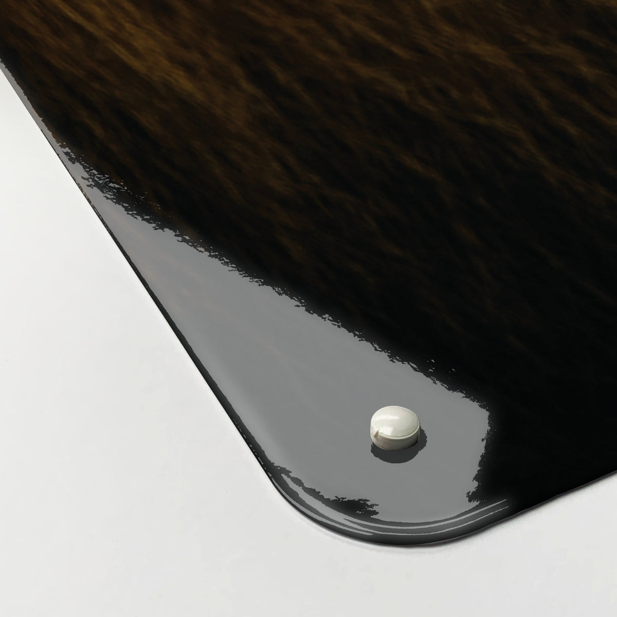 Close-up of the corner of the Lion magnetic notice board, showing the gloss finish and a screw cap