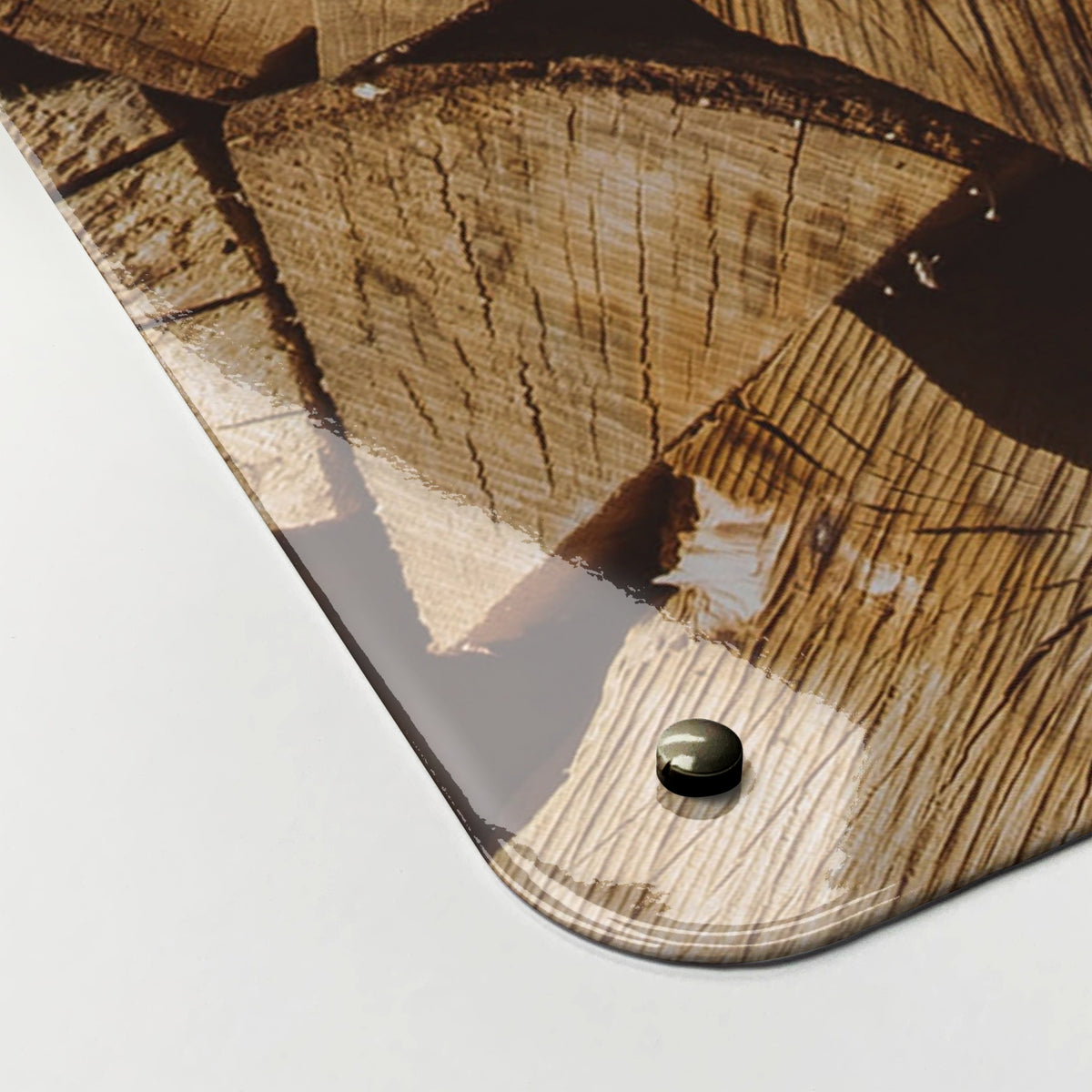 Close-up of the corner of the Log Pile magnetic notice board, showing the gloss finish and a screw cap