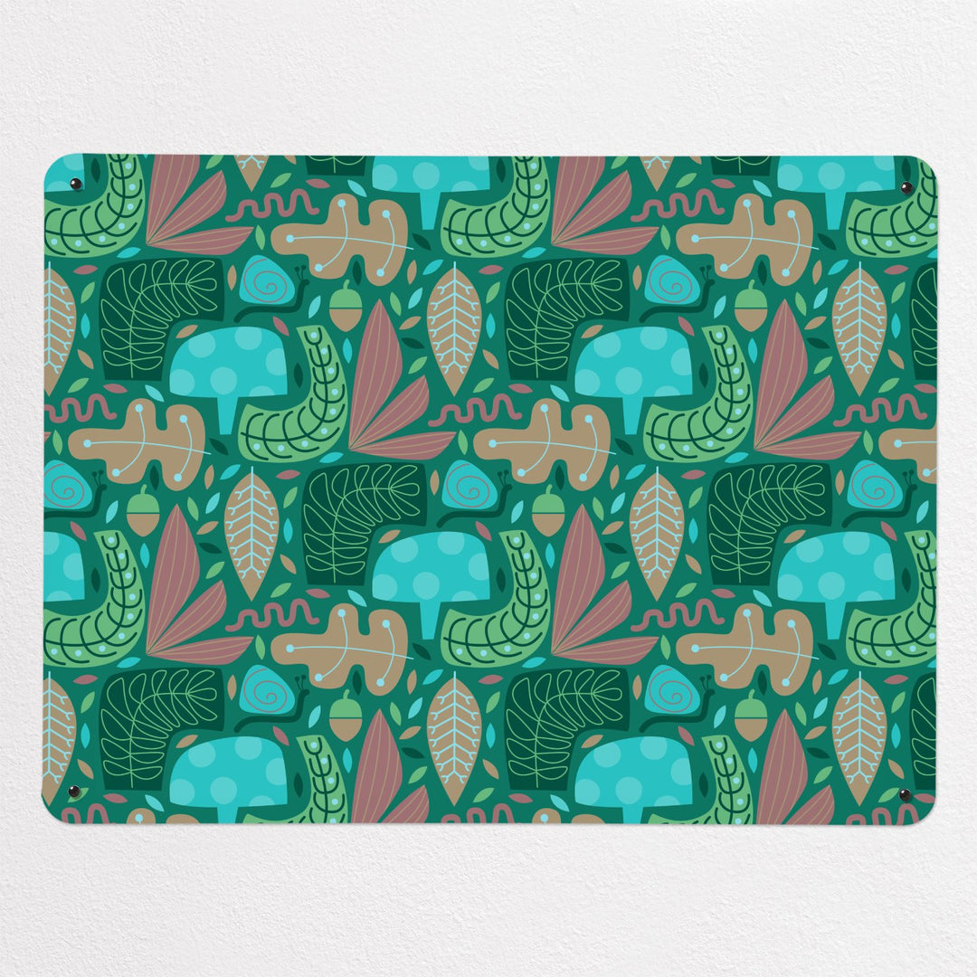 A medium magnetic notice board by Beyond the Fridge with a pattern in green, blues and pinks of a stylised forest floor with mushrooms, snails, leaves and acorns.