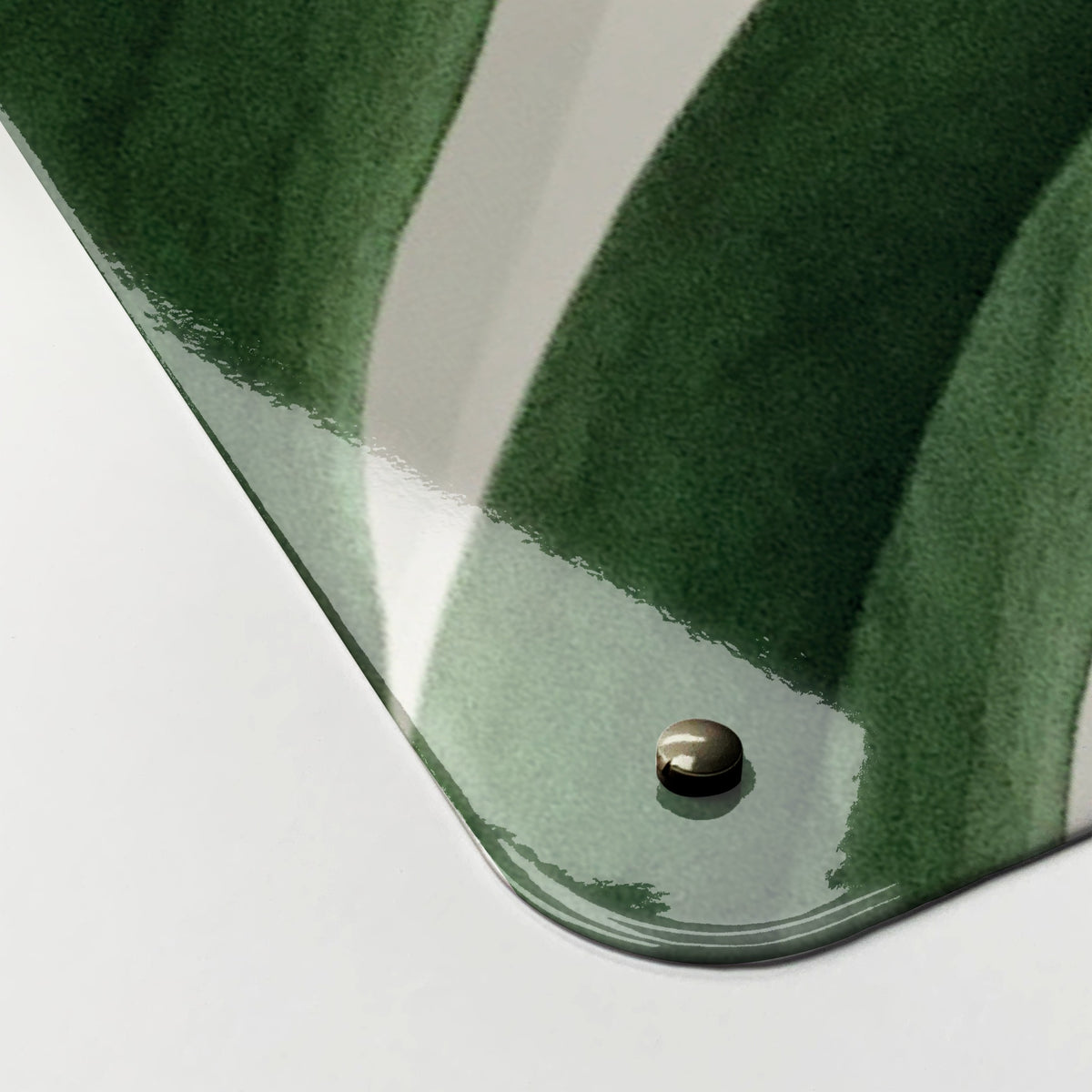 Close-up of the corner of the Monstera Plant magnetic notice board, showing the gloss finish and a screw cap