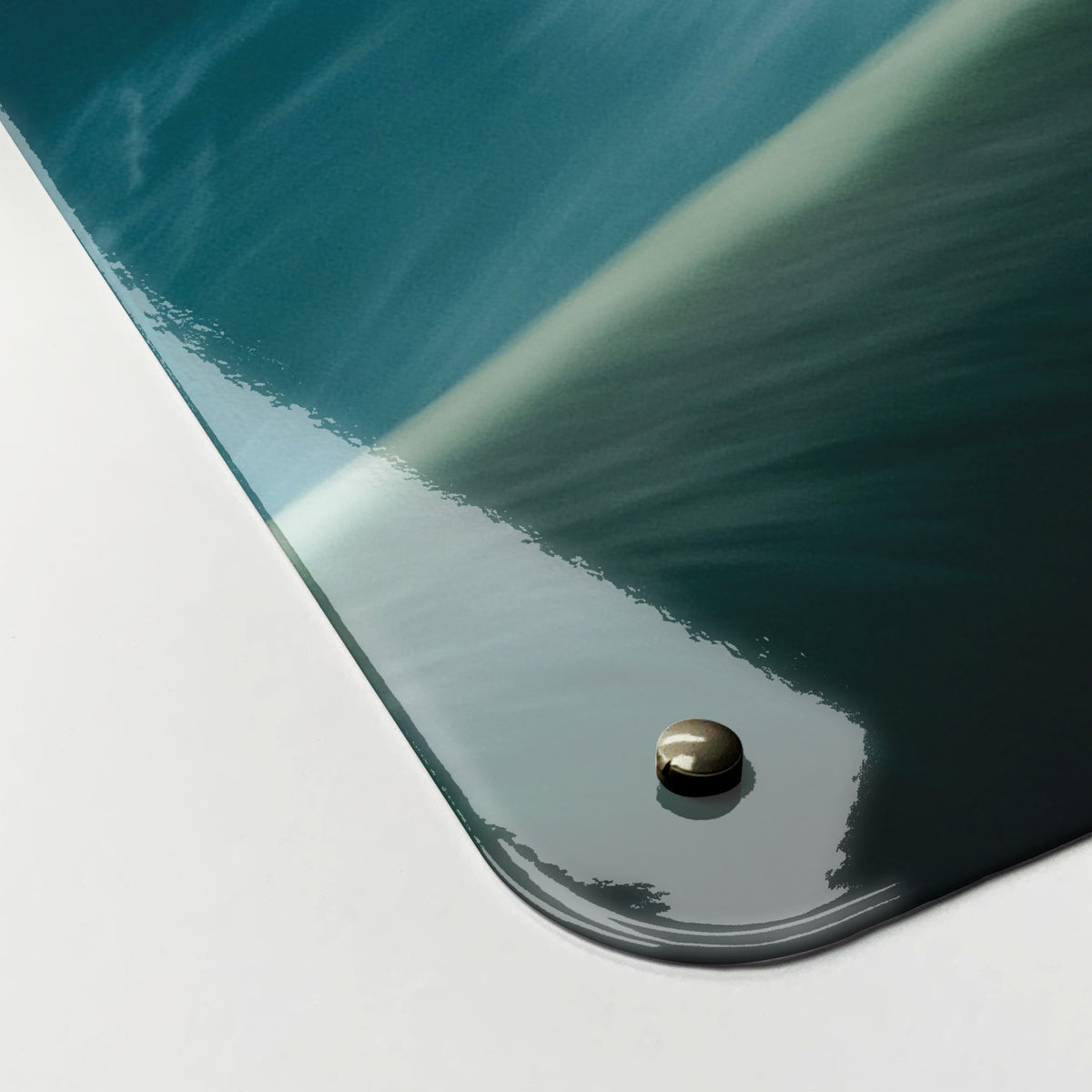 Close-up of the corner of the Niagara Falls magnetic notice board, showing the gloss finish and a screw cap