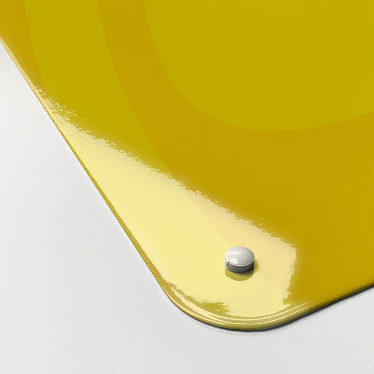 Close-up of the corner of the Oranges And Lemons magnetic notice board in Oranges and Lemons, showing the gloss finish and a screw cap