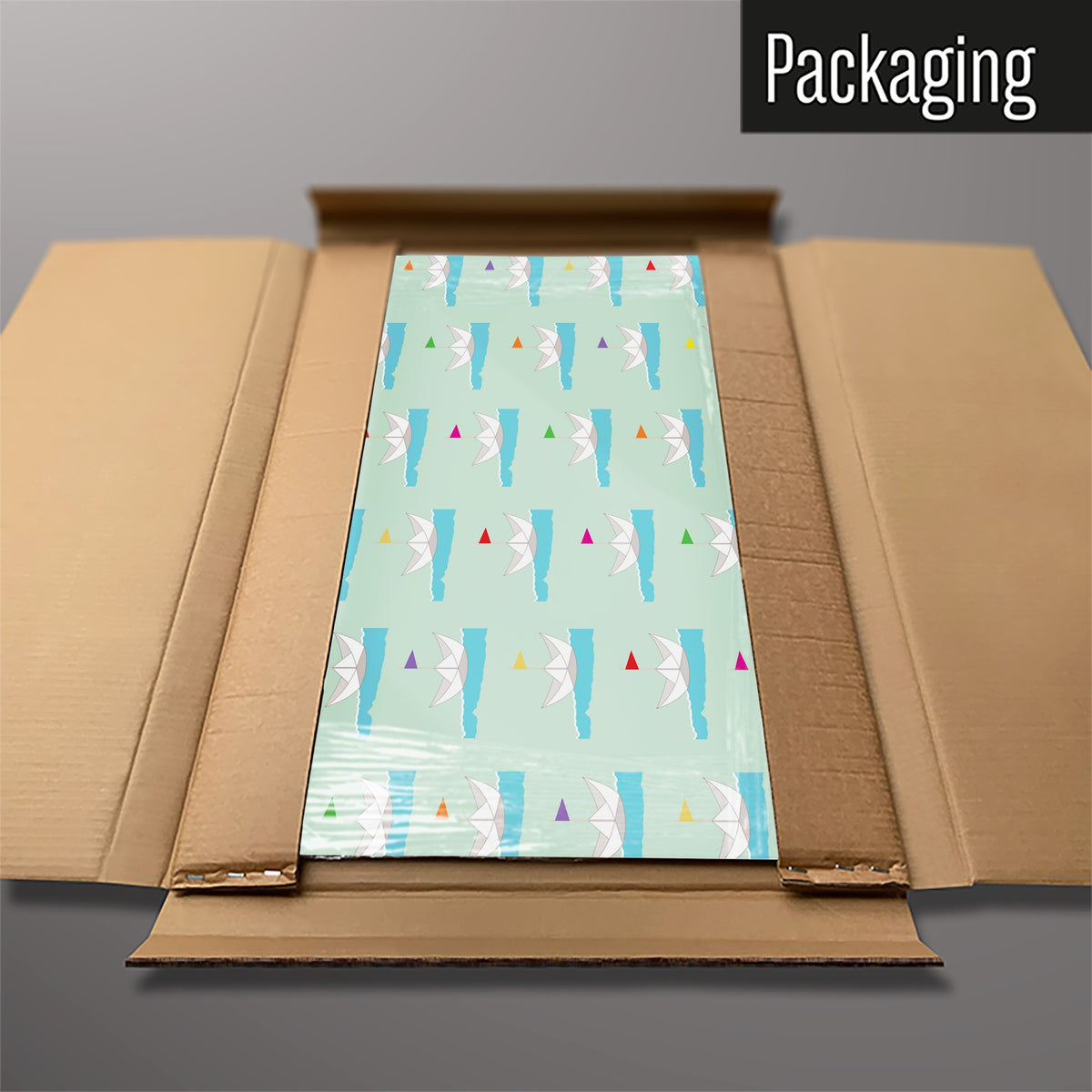 The Paper Boats magnetic notice board in Paper Boats packed flat in its cardboard box