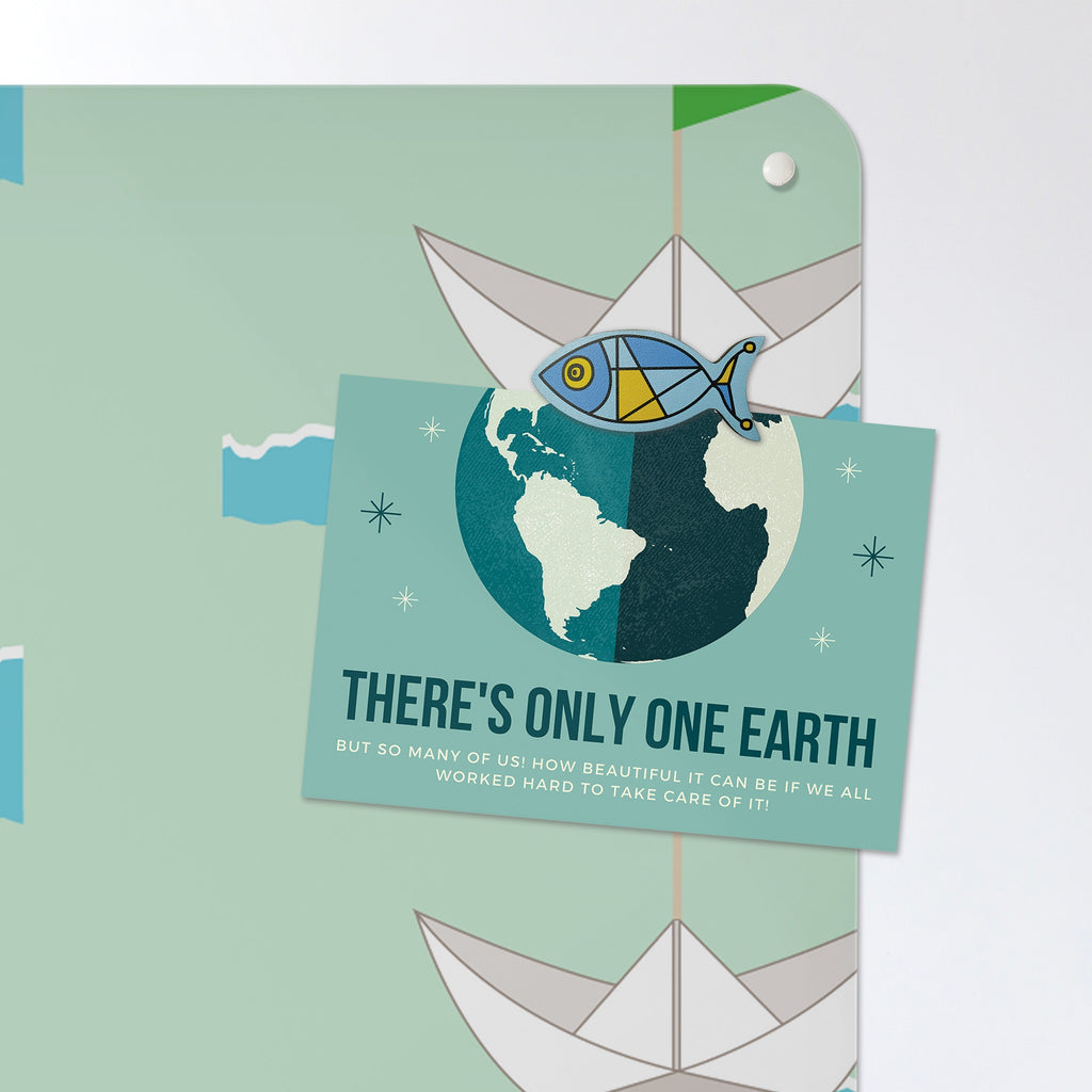 A postcard held by a fridge magnet on the Paper Boats magnetic notice board in Paper Boats