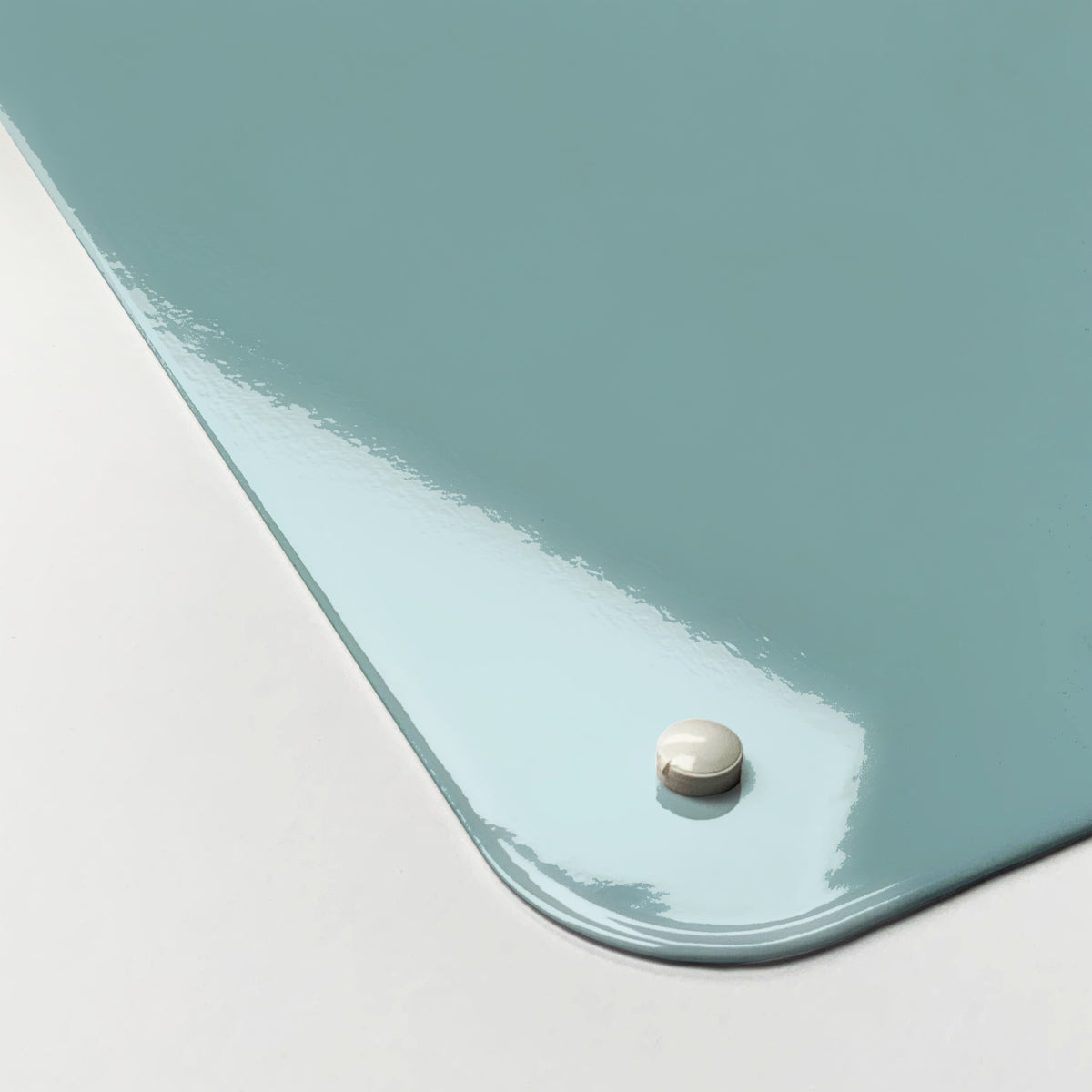 Close-up of the corner of the Plain Blue magnetic notice board, showing the gloss finish and a screw cap