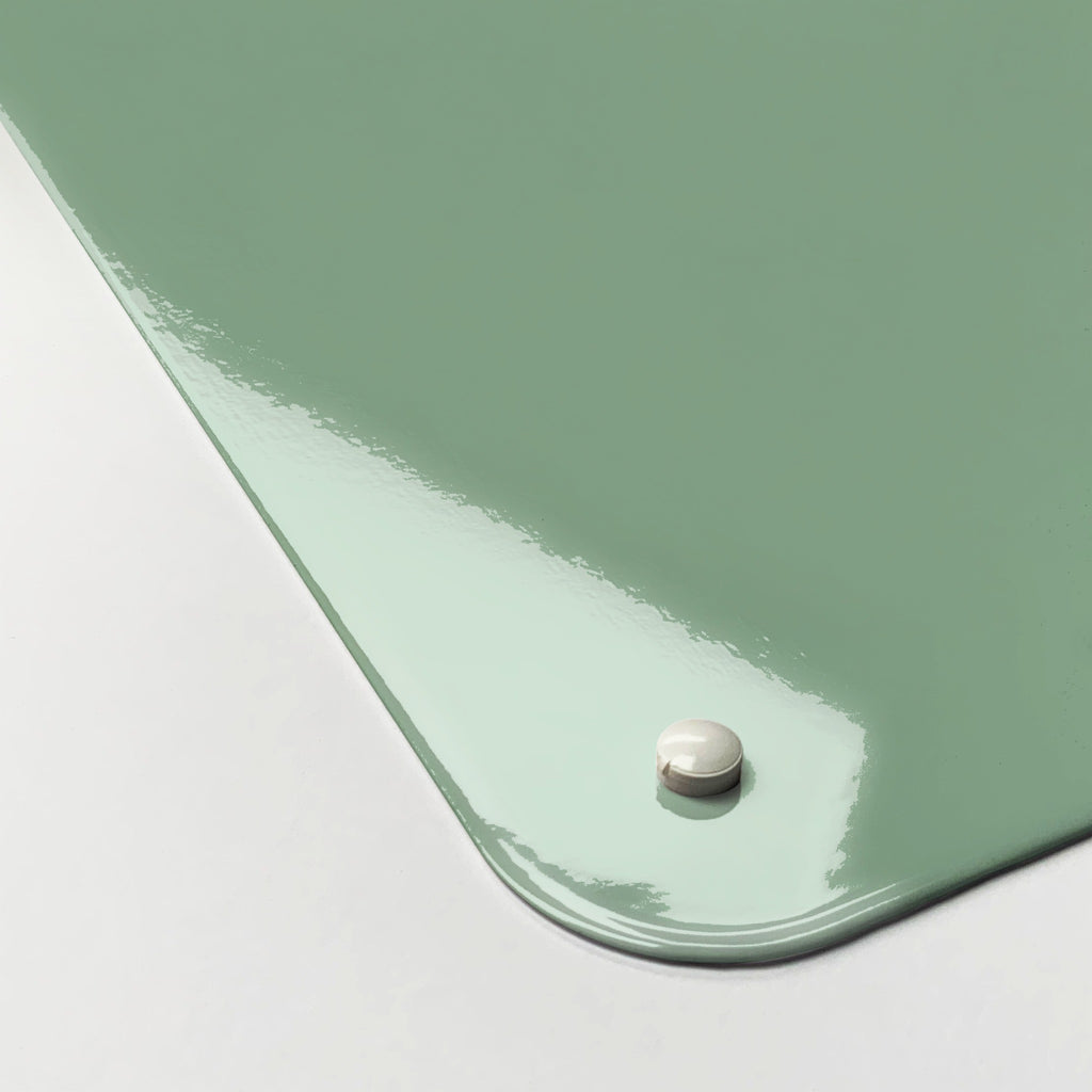 Close-up of the corner of the Plain Green magnetic notice board, showing the gloss finish and a screw cap