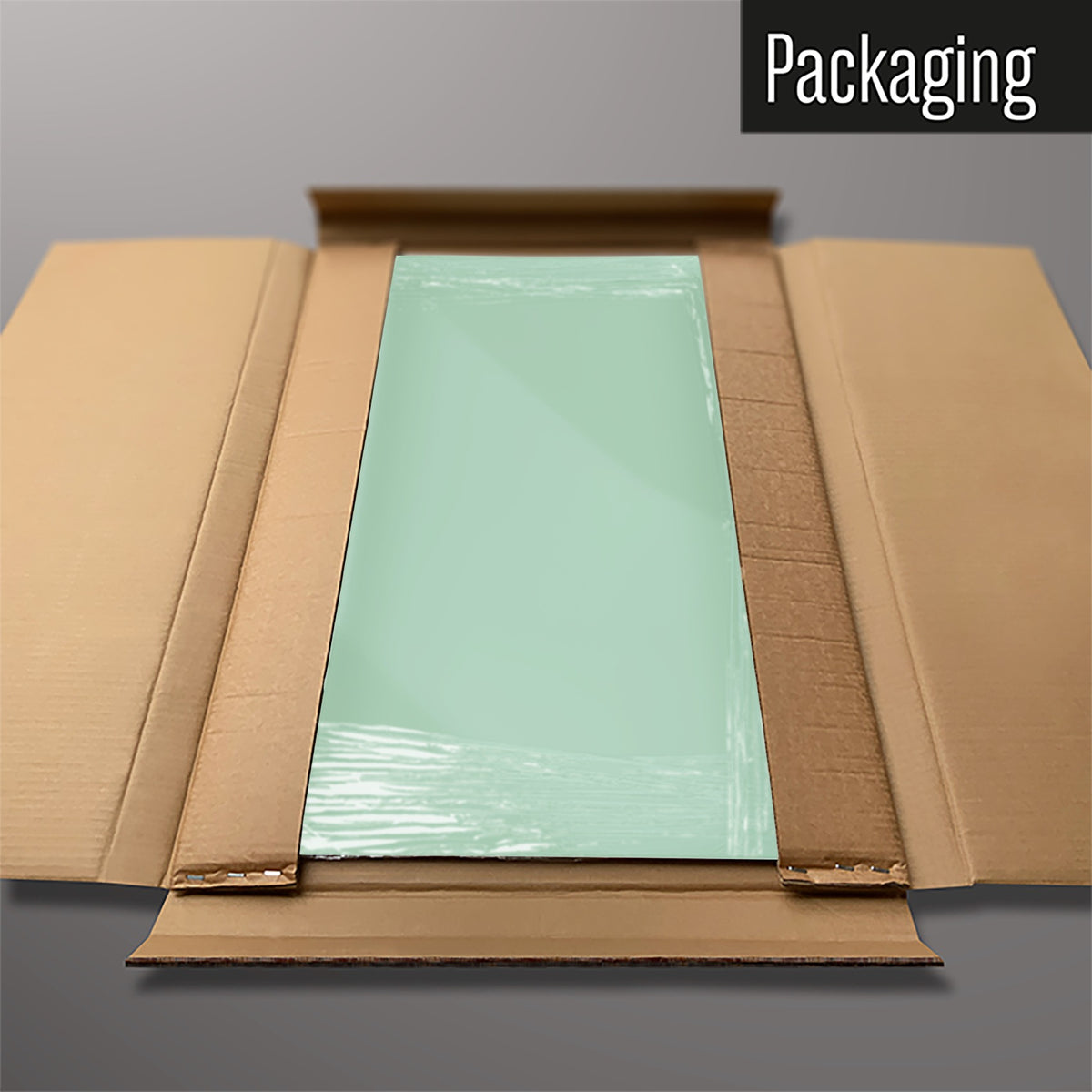 The Plain Green magnetic notice board packed flat in its cardboard box