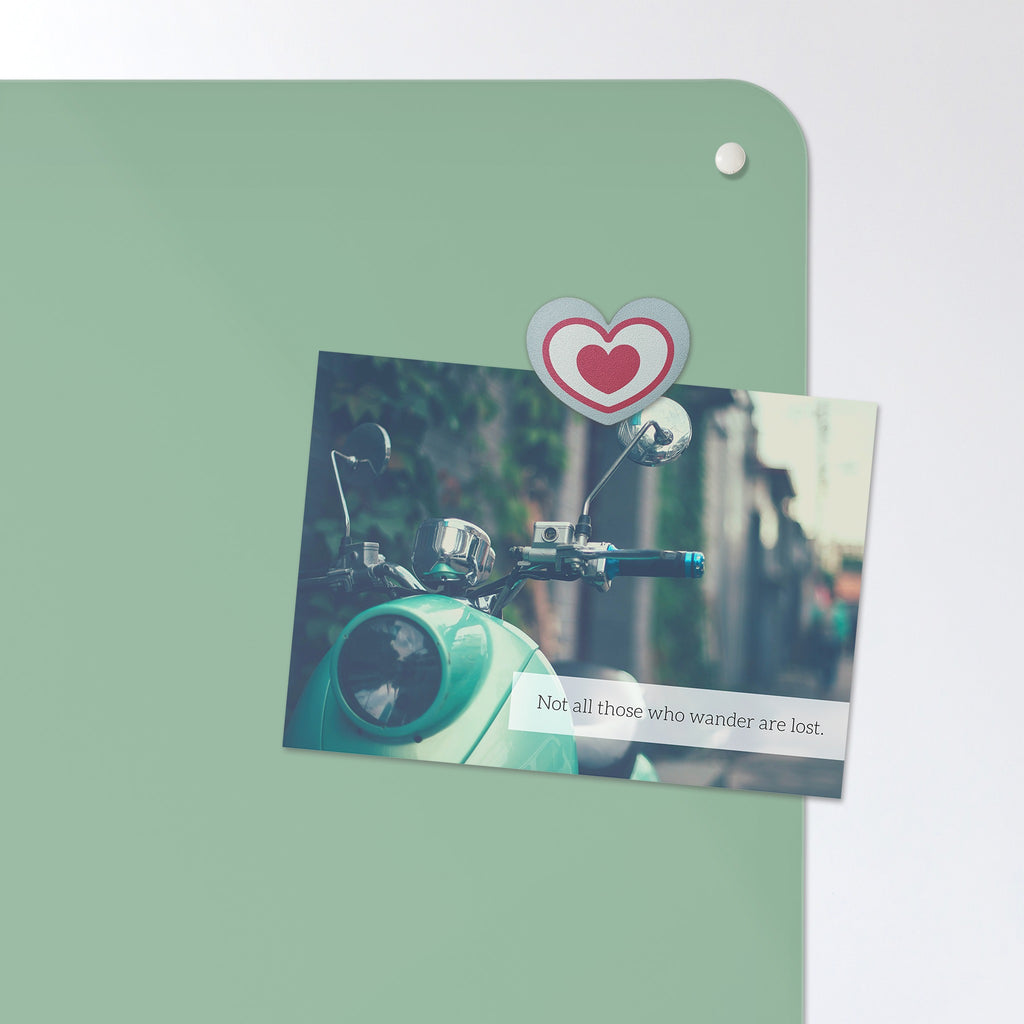 A postcard held by a fridge magnet on the Plain Green magnetic notice board