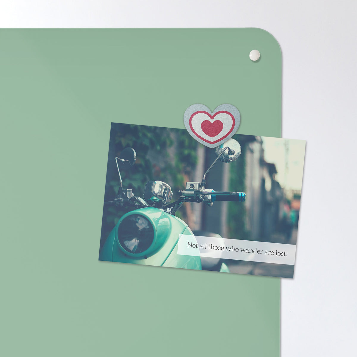 A postcard held by a fridge magnet on the Plain Green magnetic notice board