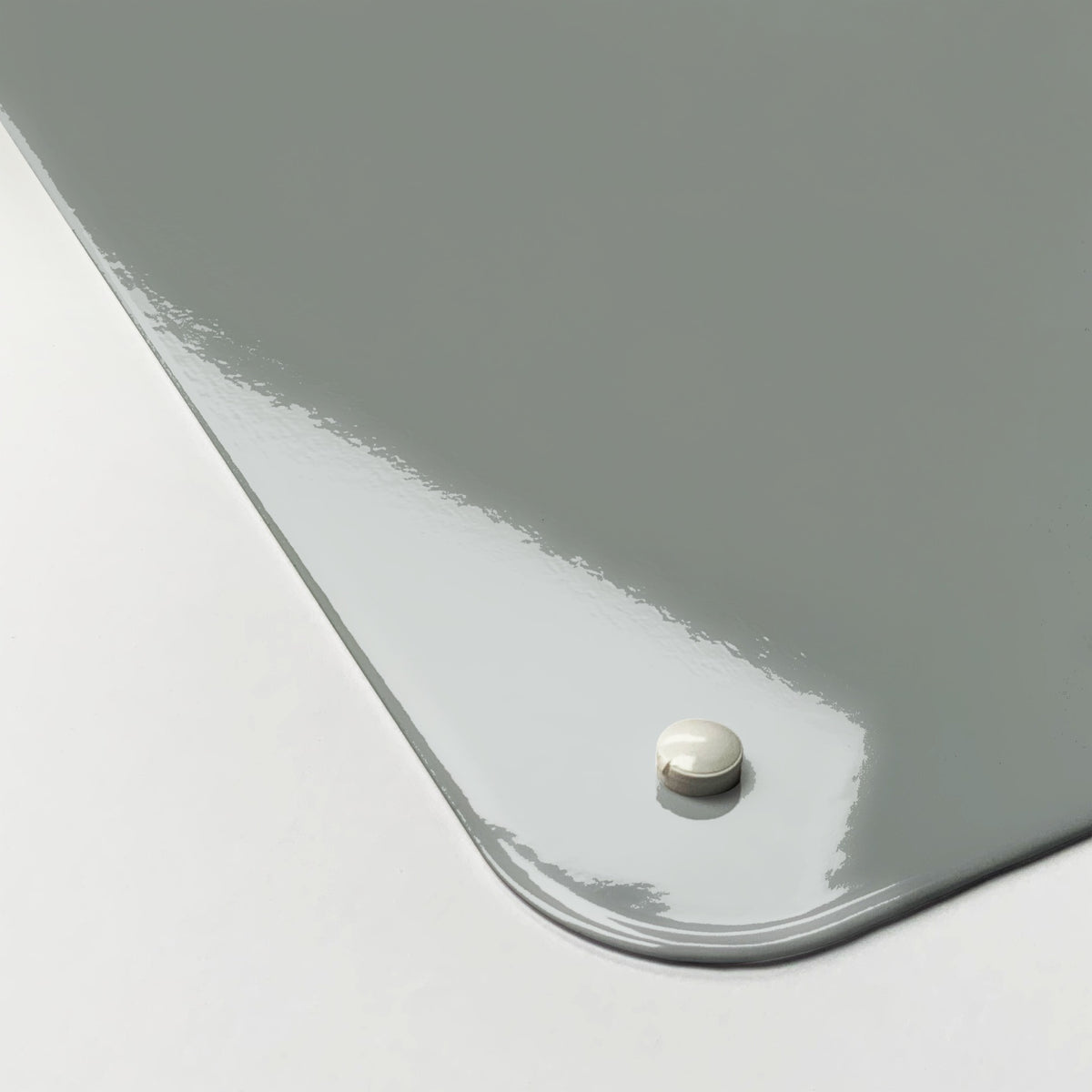 Close-up of the corner of the Plain Grey magnetic notice board, showing the gloss finish and a screw cap