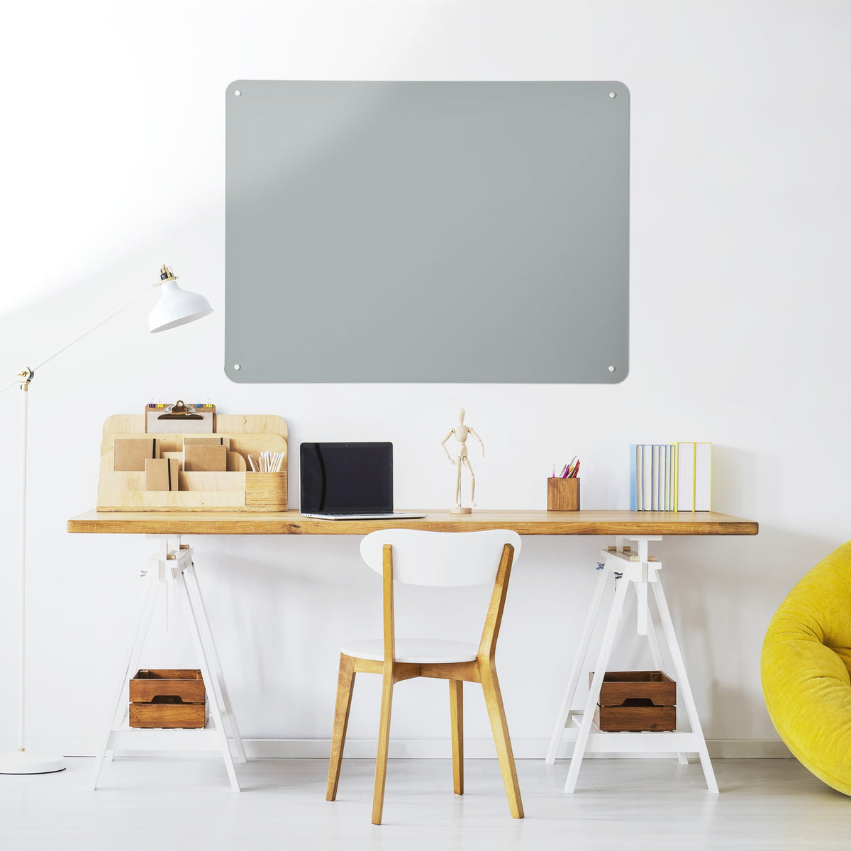 Plain Grey magnetic notice board above a desk in a home office