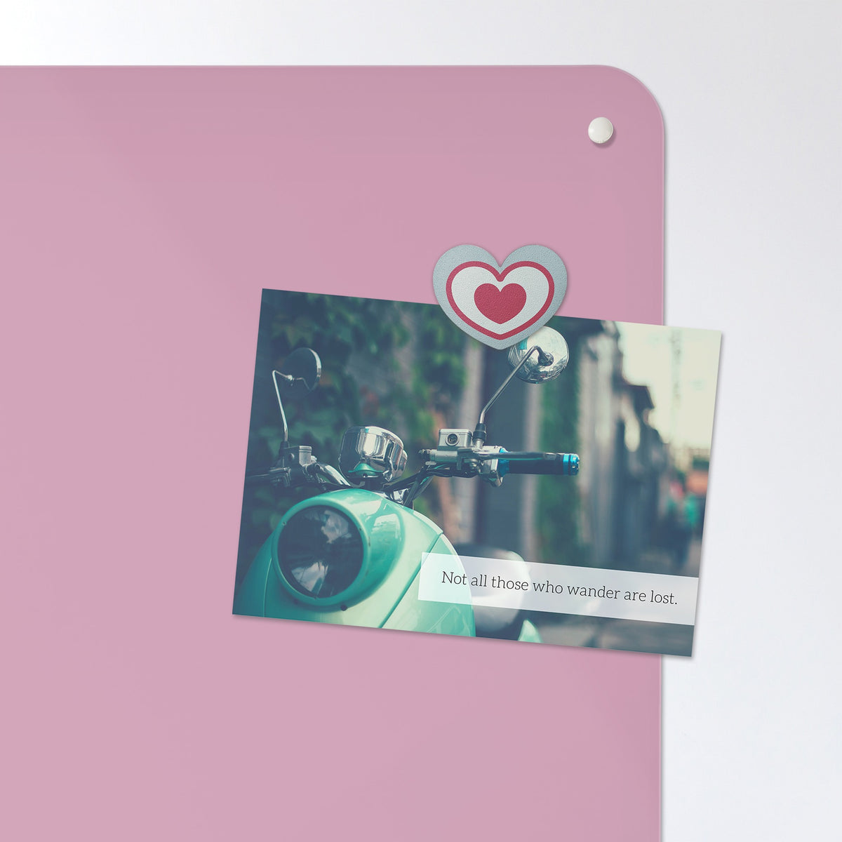 A postcard held by a fridge magnet on the Plain Pink magnetic notice board