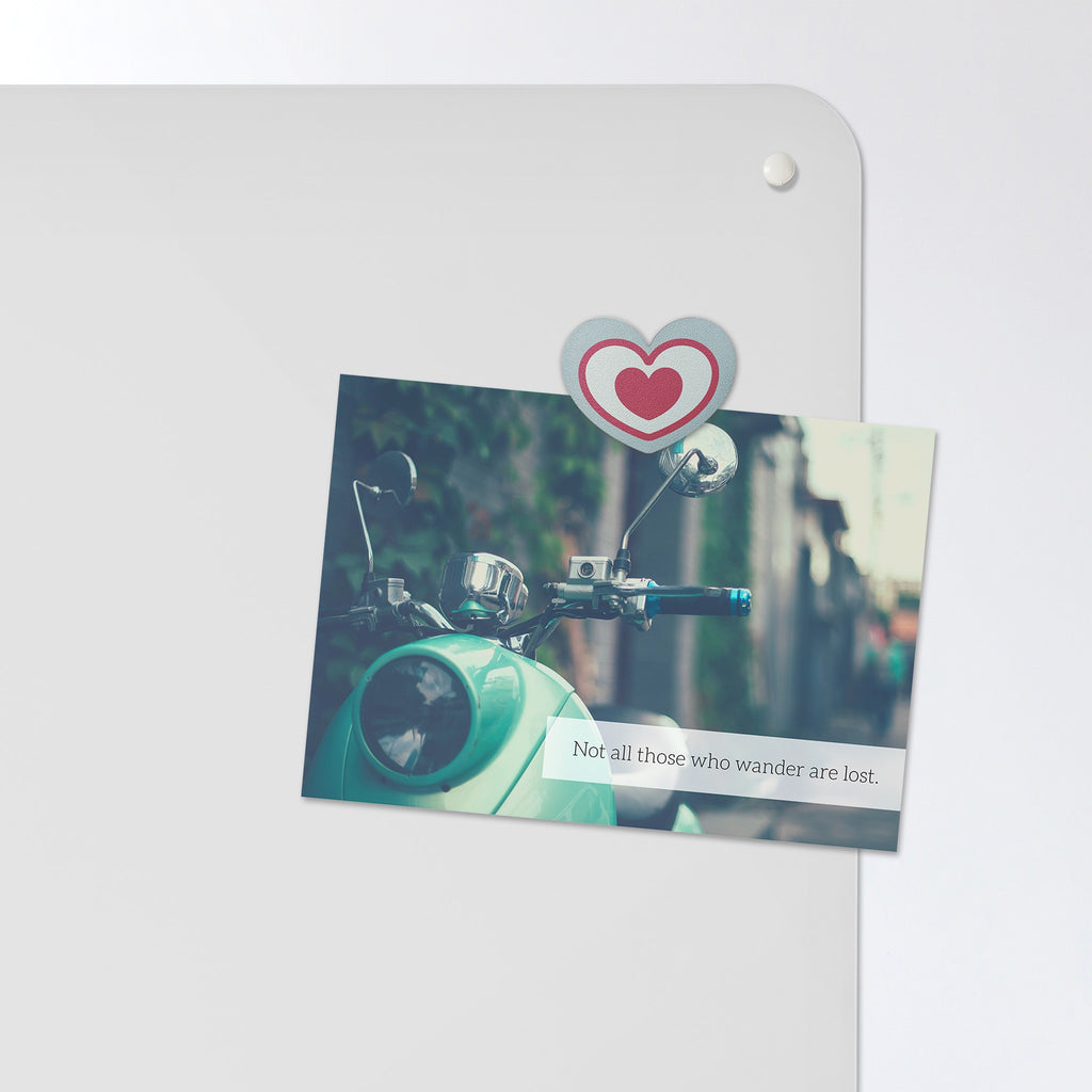A postcard held by a fridge magnet on the Plain White magnetic notice board