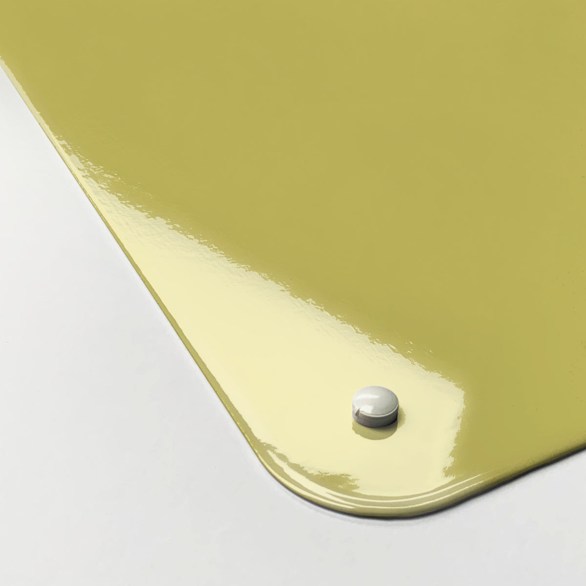 Close-up of the corner of the Plain Yellow magnetic notice board, showing the gloss finish and a screw cap