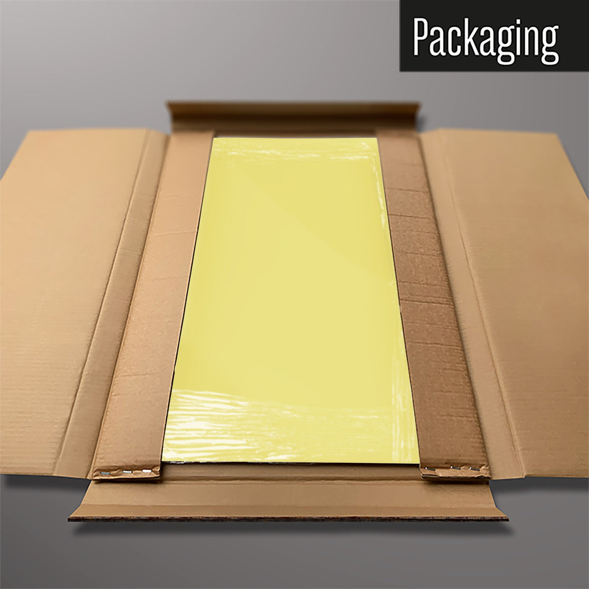 The Plain Yellow magnetic notice board packed flat in its cardboard box