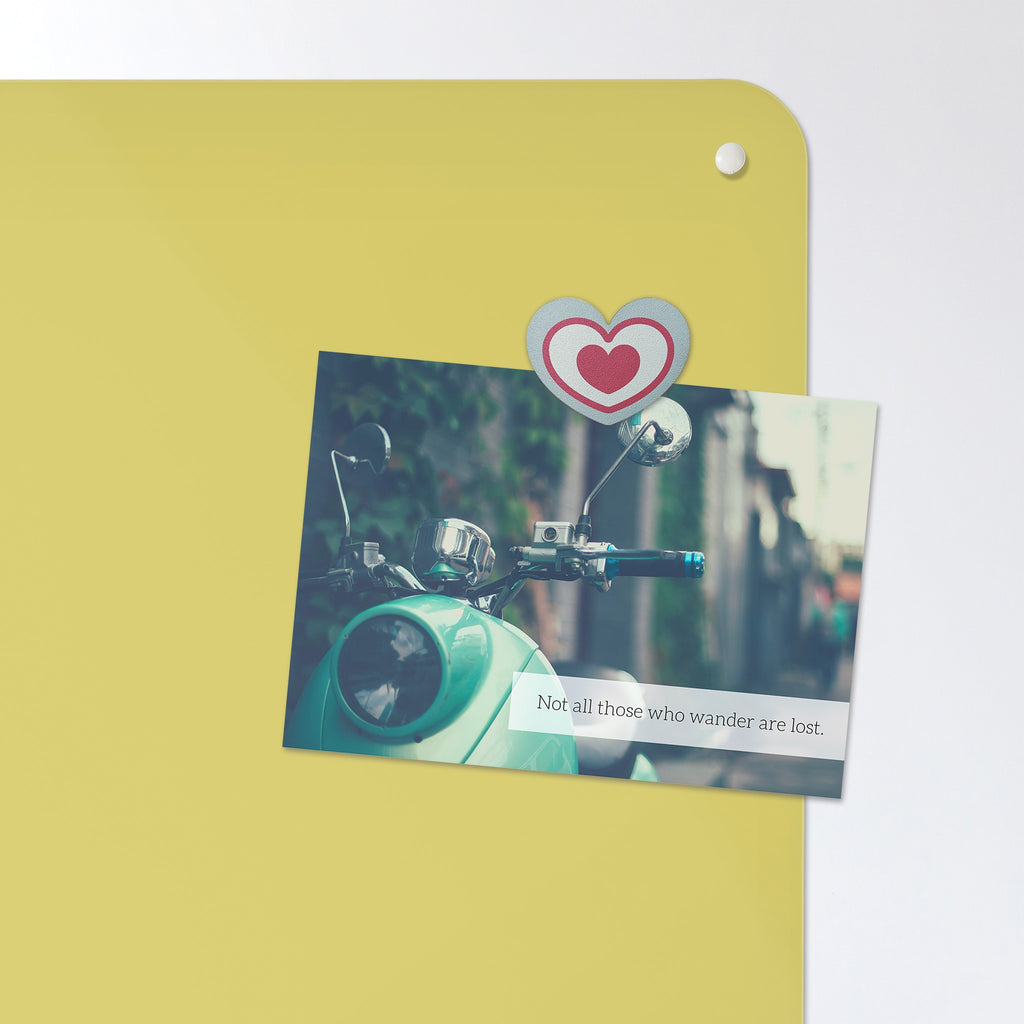 A postcard held by a fridge magnet on the Plain Yellow magnetic notice board