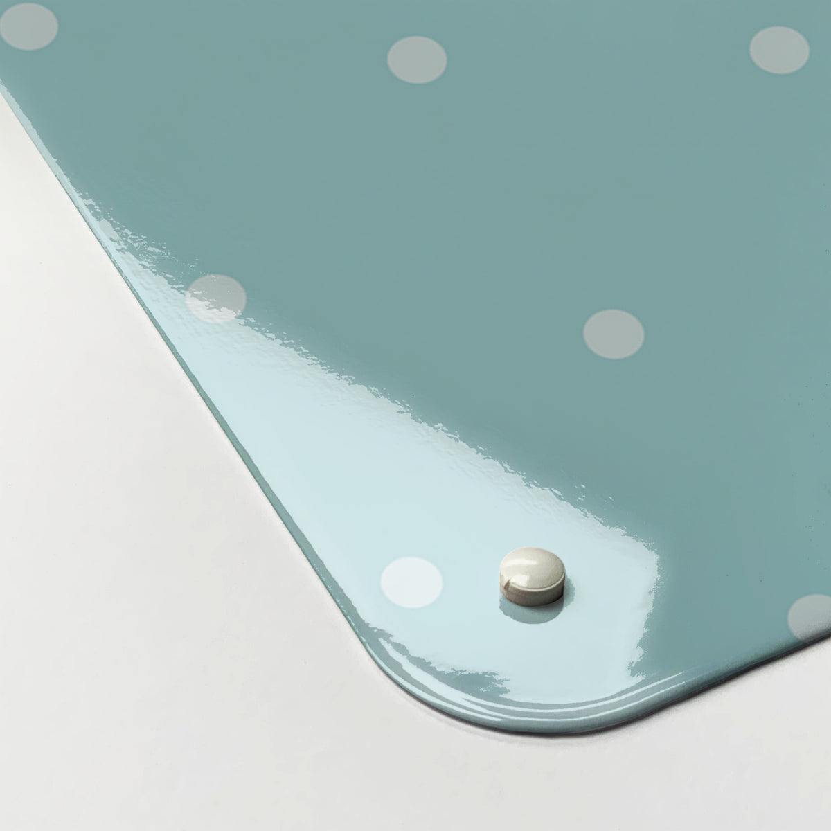 Close-up of the corner of the Polka Dots Design magnetic notice board in Blue, showing the gloss finish and a screw cap