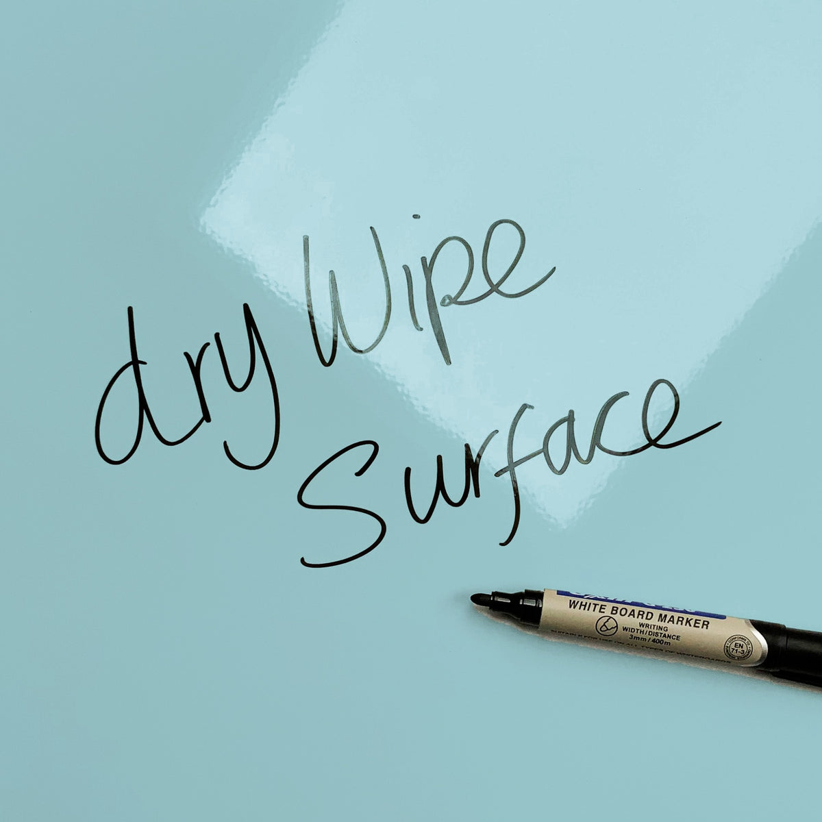 The words dry wipe surface written in marker pen on the Blue Polka Dots Design magnetic notice board
