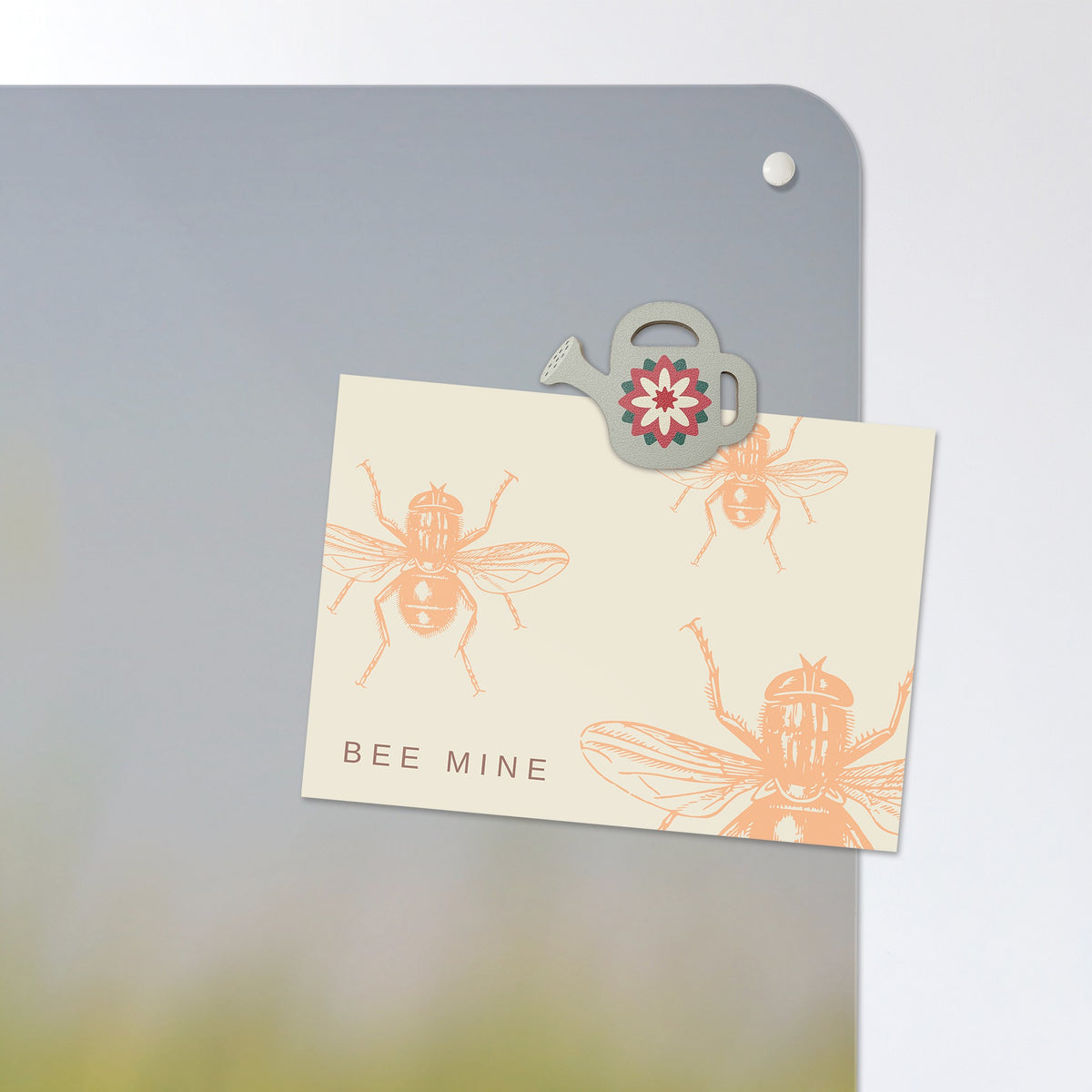 A postcard held by a fridge magnet on the Poppy Field magnetic notice board