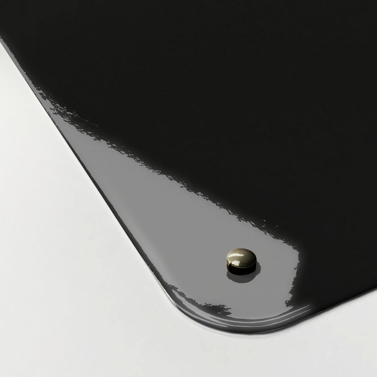 Close-up of the corner of the Rock Climbing magnetic notice board, showing the gloss finish and a screw cap