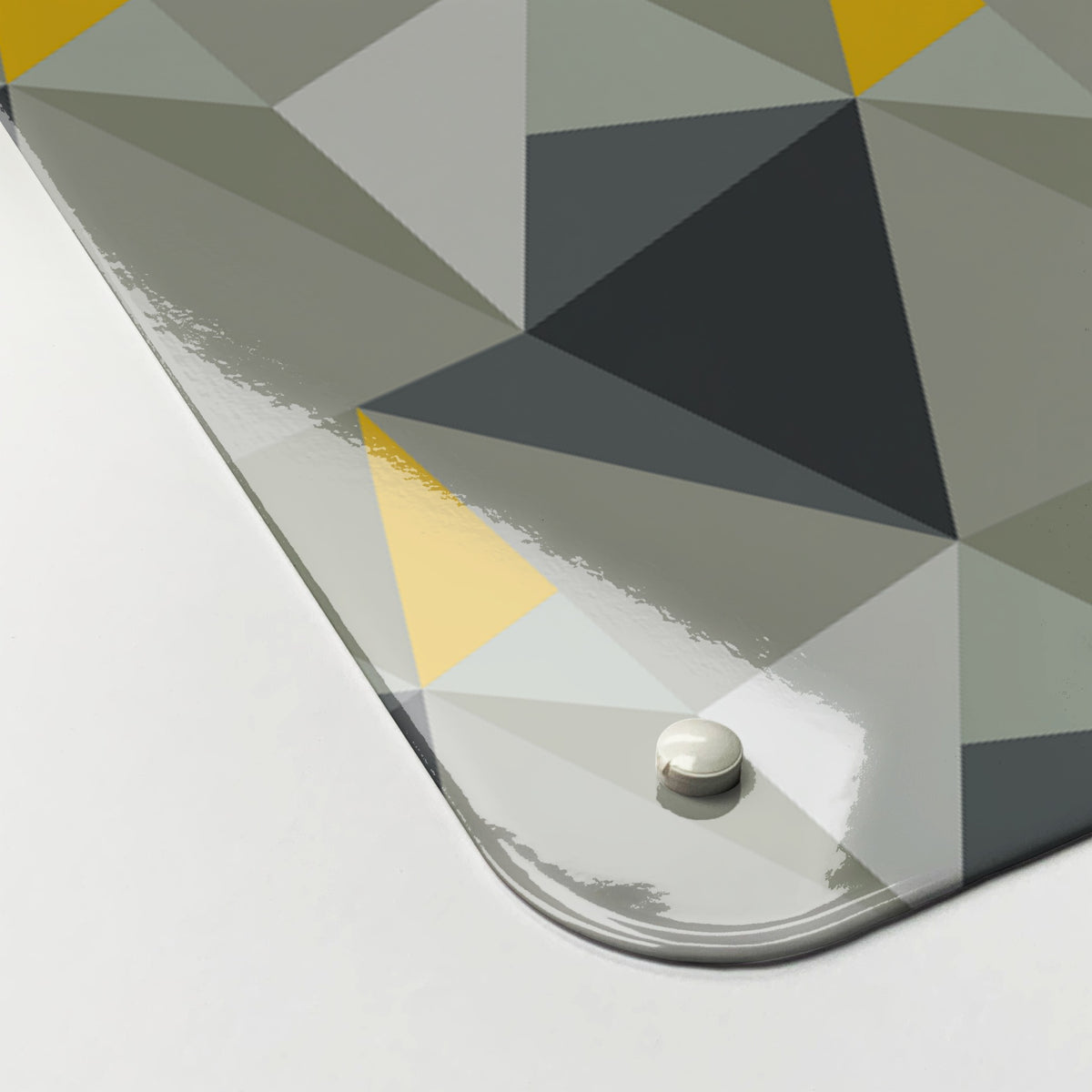 Close-up of the corner of the Shards Design magnetic notice board in Concrete and Yellow, showing the gloss finish and a screw cap