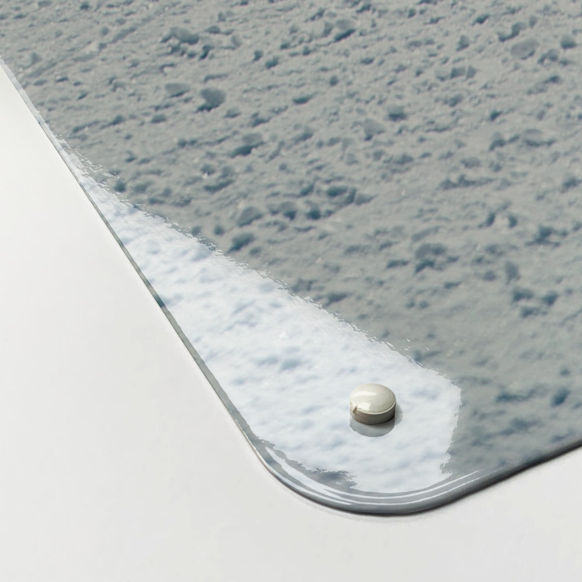 Close-up of the corner of the Snowboarding magnetic notice board, showing the gloss finish and a screw cap