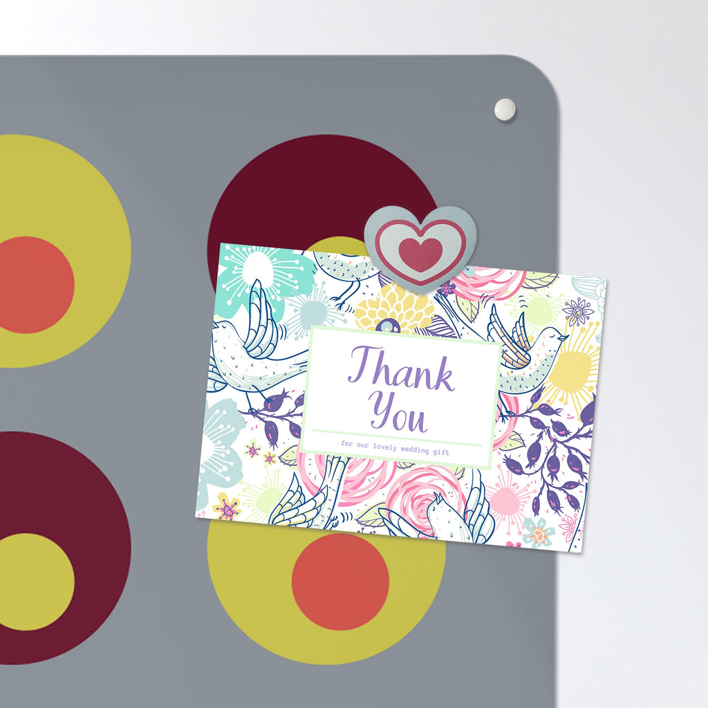 A postcard held by a fridge magnet on the Spots magnetic notice board in Spots on Grey