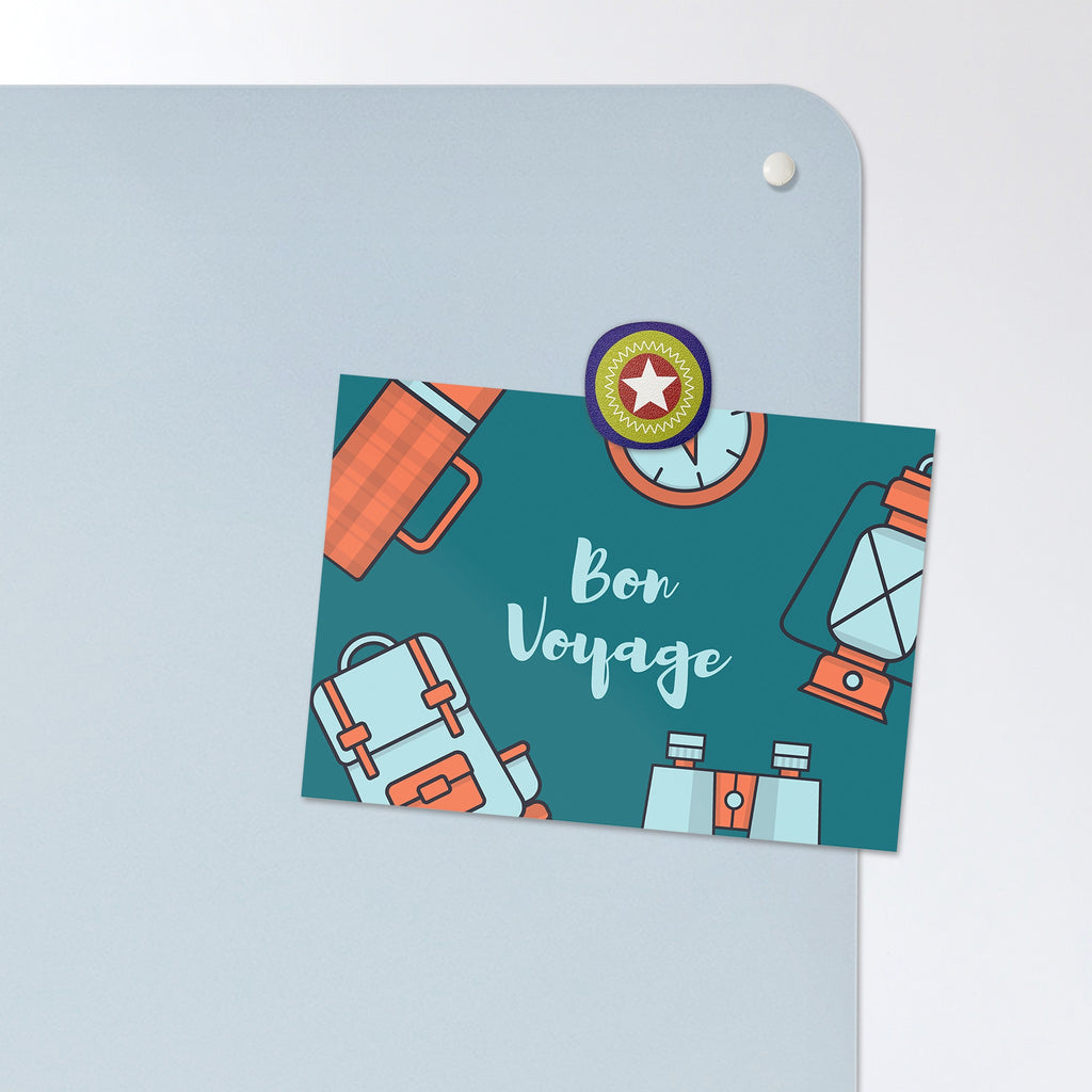 A postcard held by a fridge magnet on the Statue Of Liberty magnetic notice board