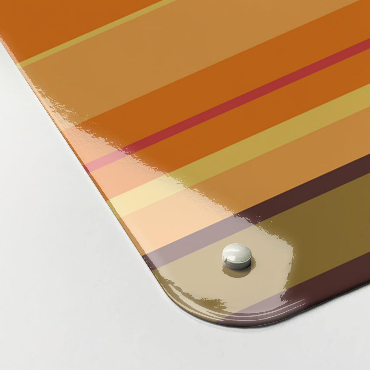 Close-up of the corner of the Stripes magnetic notice board in Stripes - Pumpkin, showing the gloss finish and a screw cap